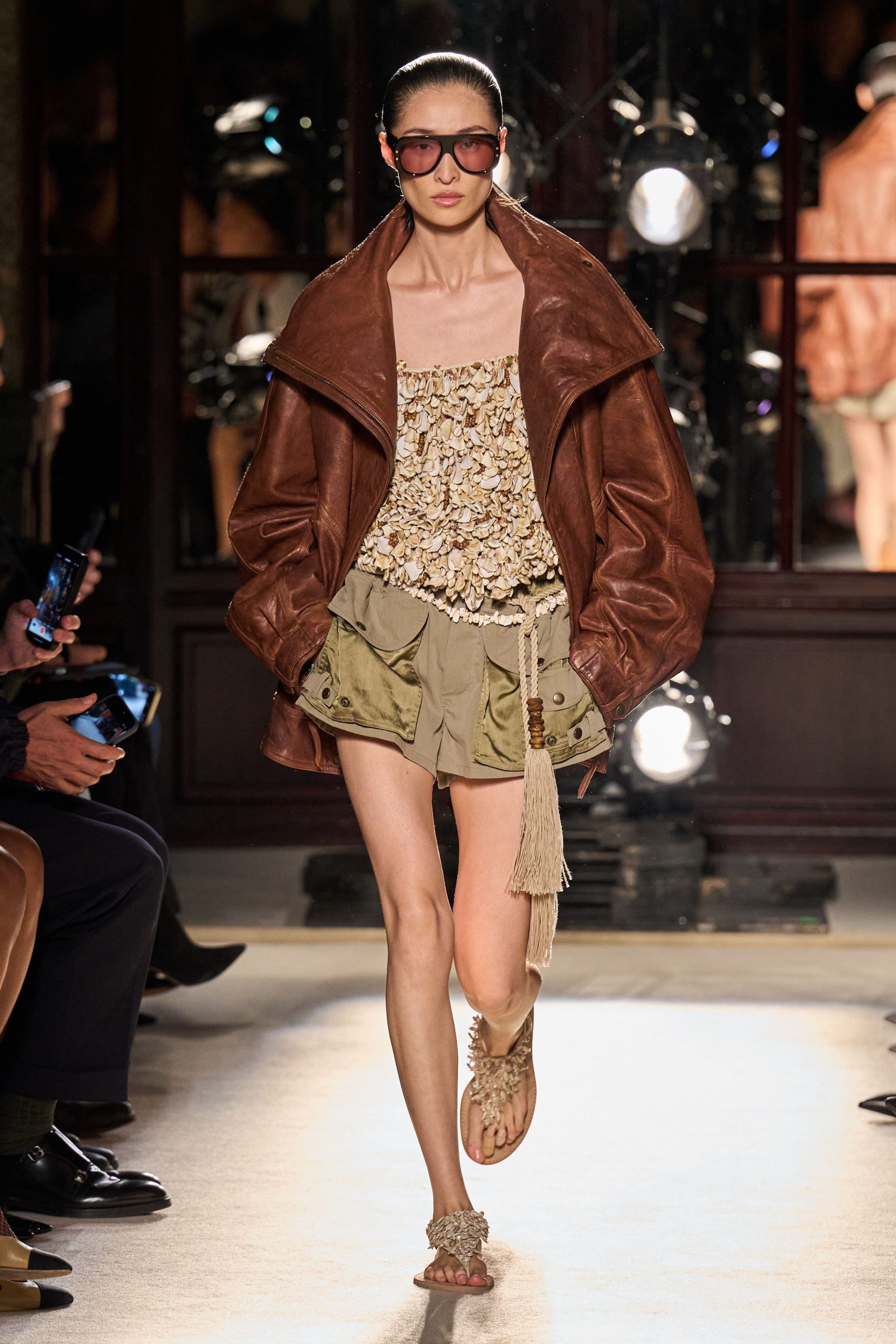 beige embroidered sleeveless top with oversized brown leather jacket