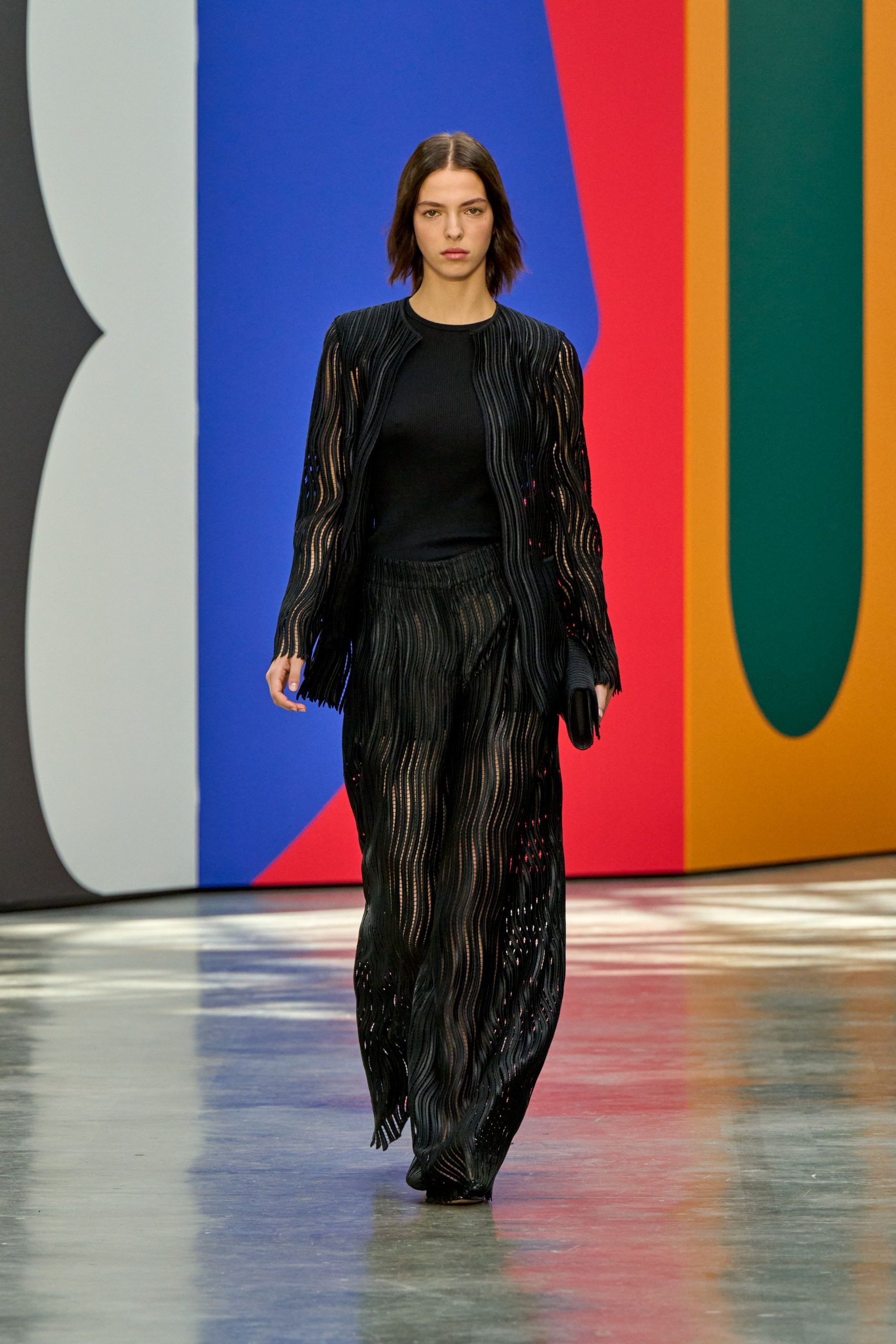 black silk layered top and wide-leg pants