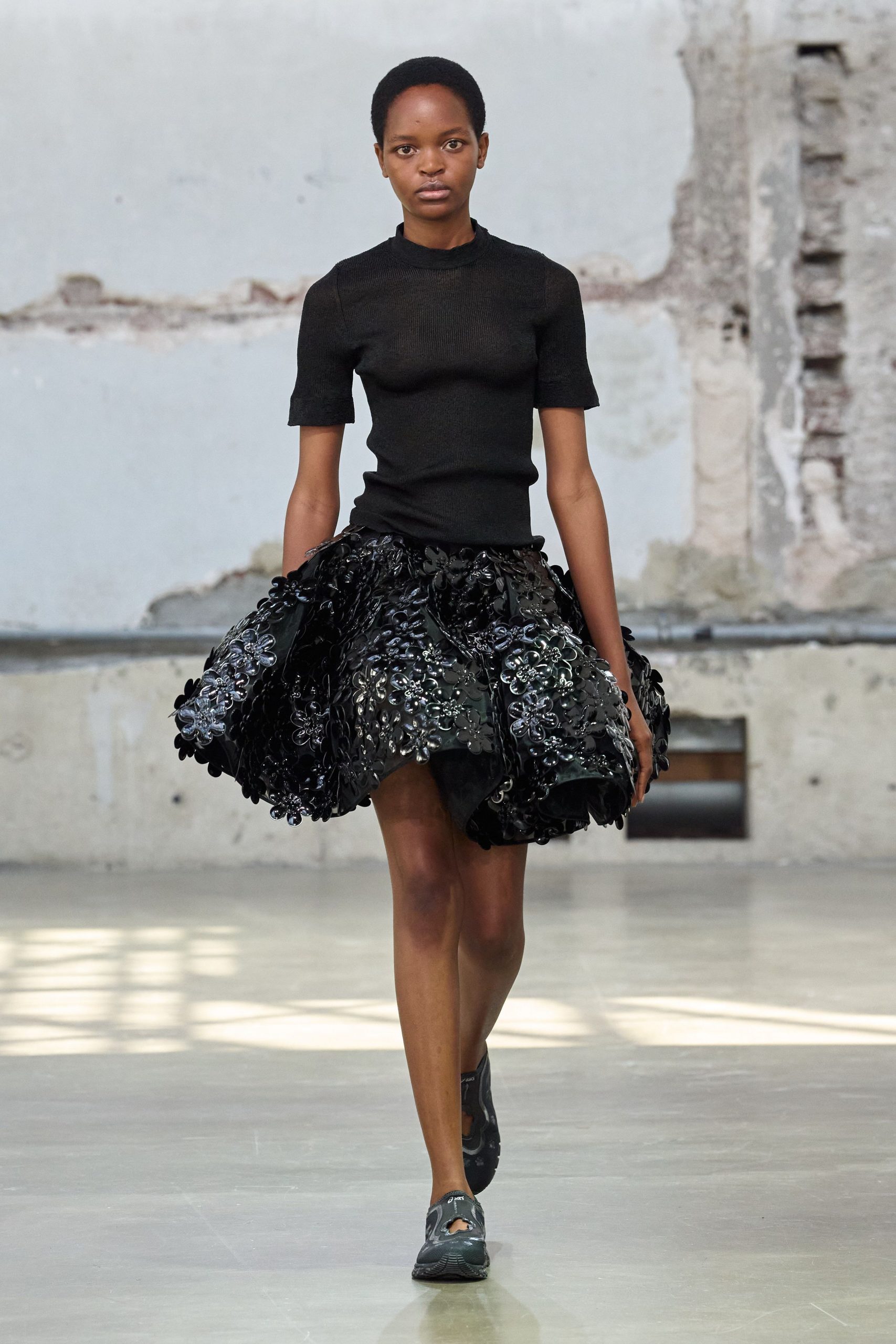 black fitted top and mini skirt