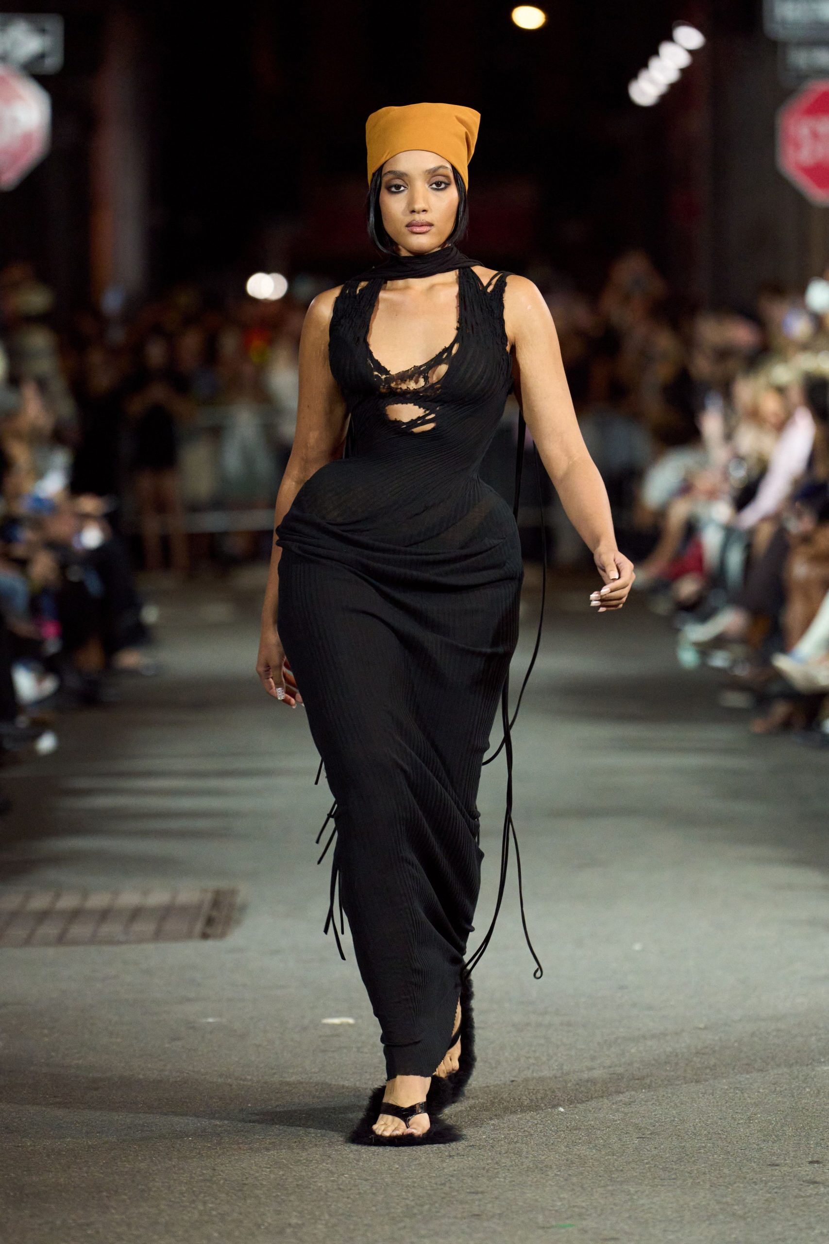 black fitted midi dress with orange hat
