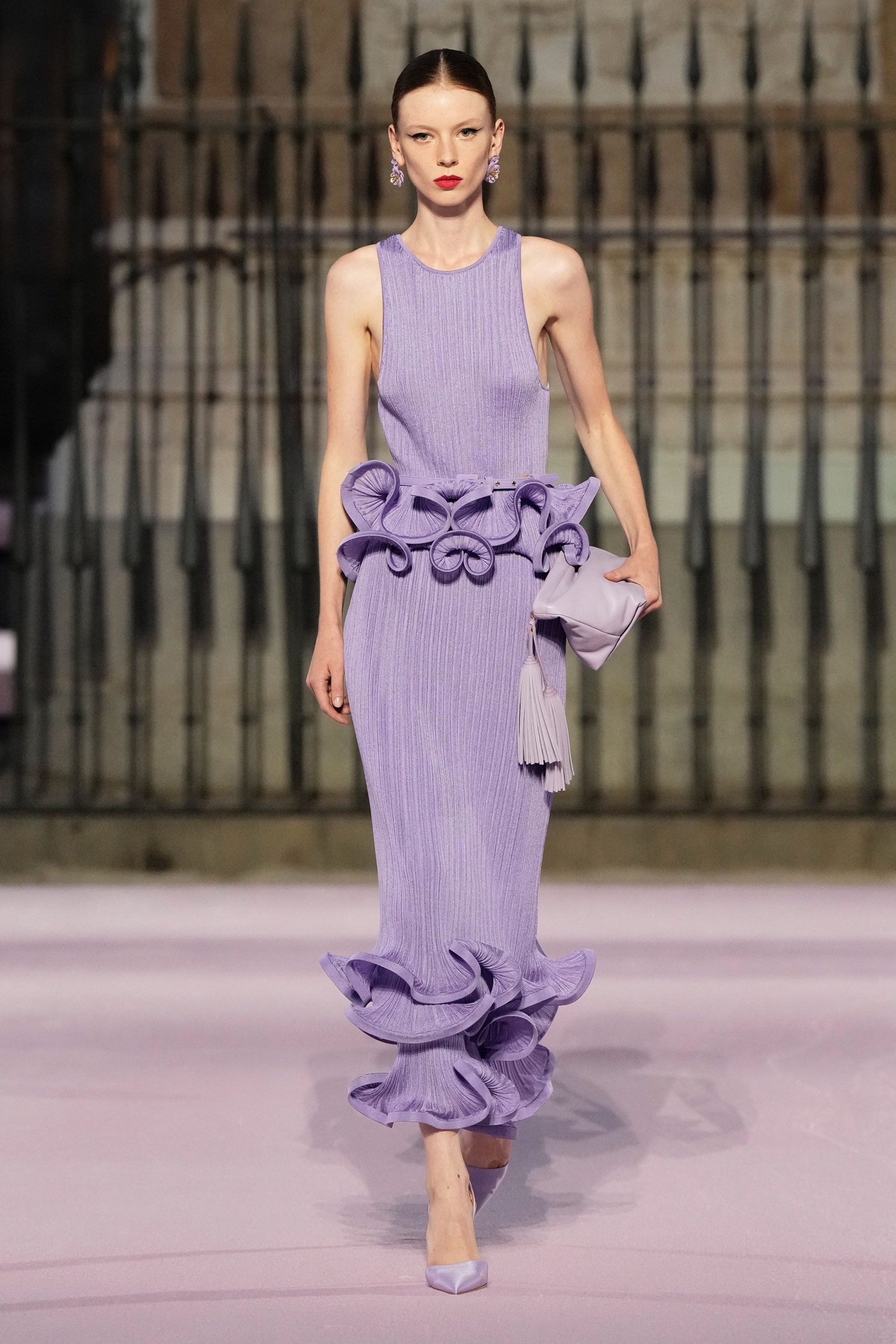 purple ruffled gown with clutch