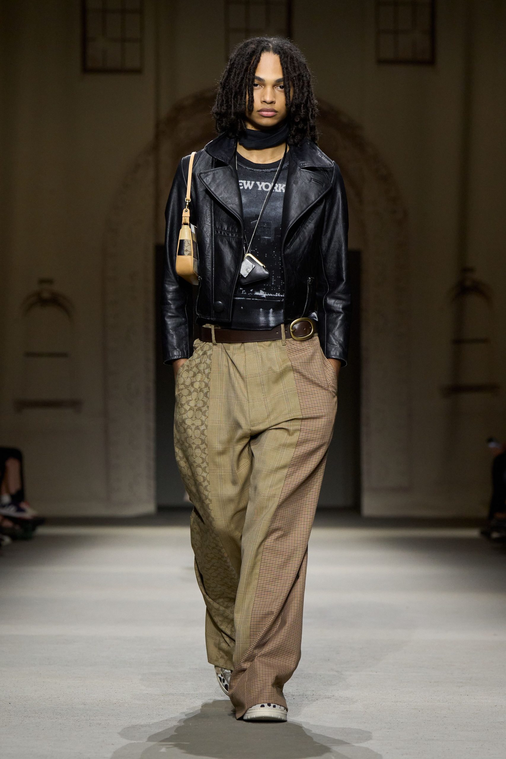 black leather jacket with beige pants