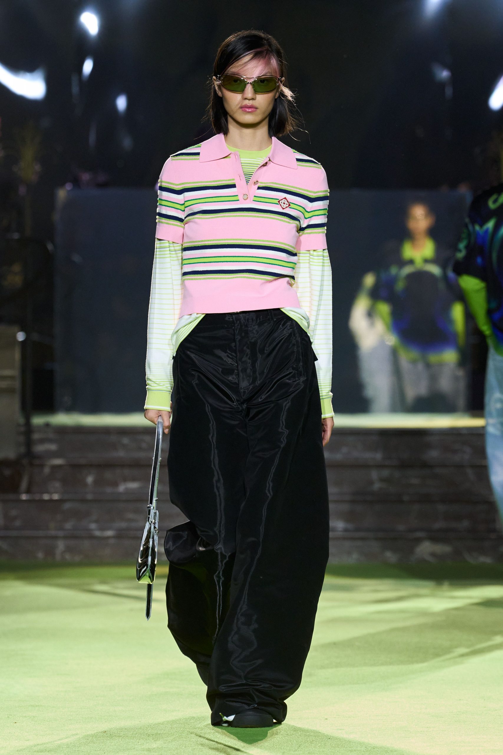 pink striped long-sleeve top with black pants