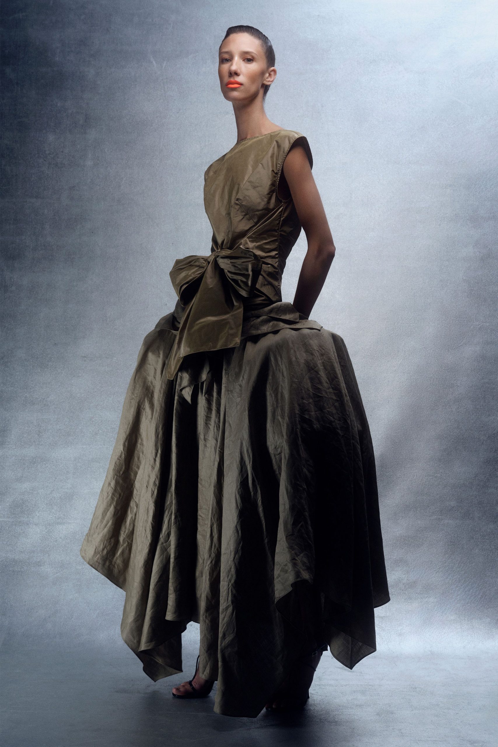 green silk sleeveless high-neck fitted tiered belted gown