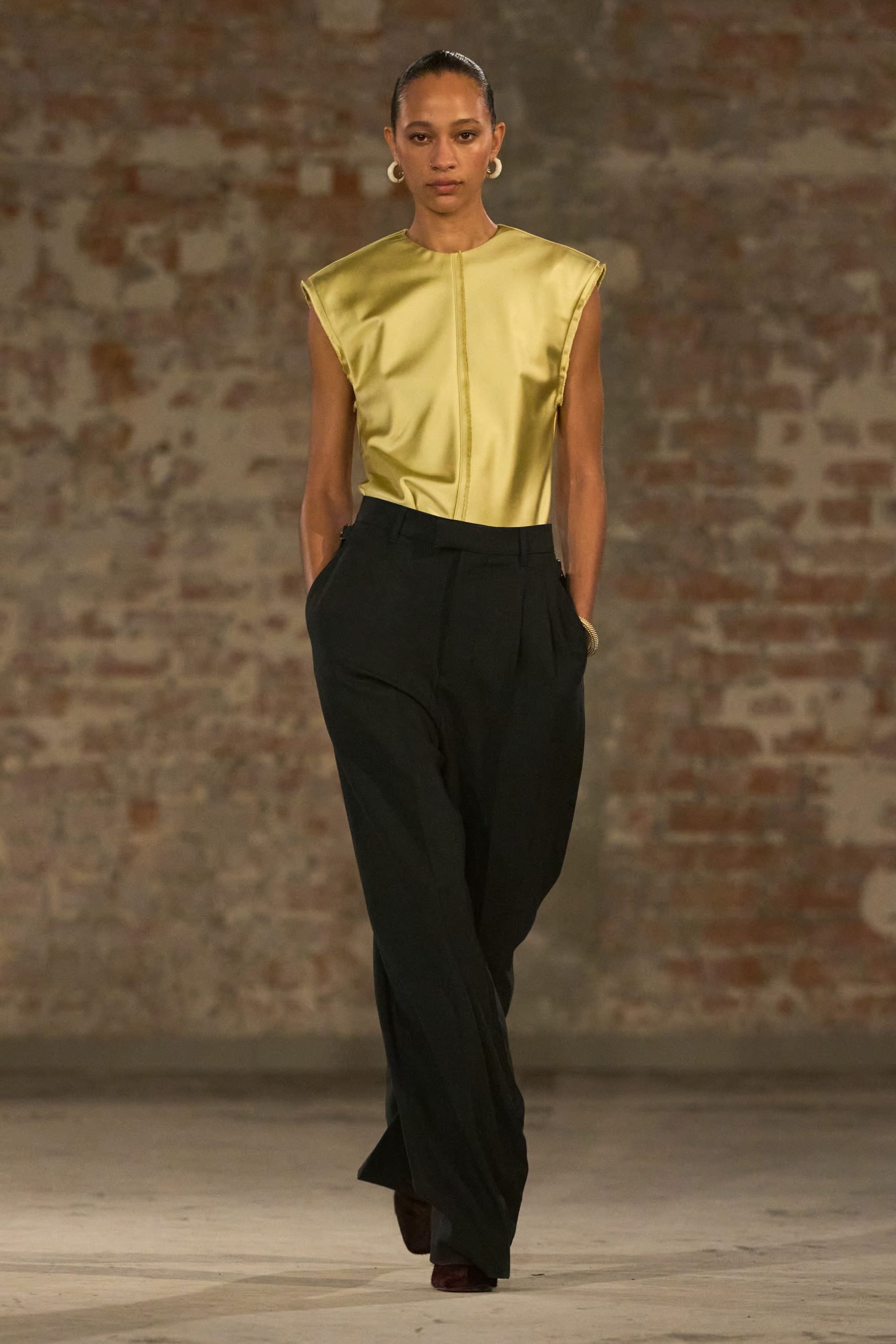 yellow silk sleeveless top with black pants