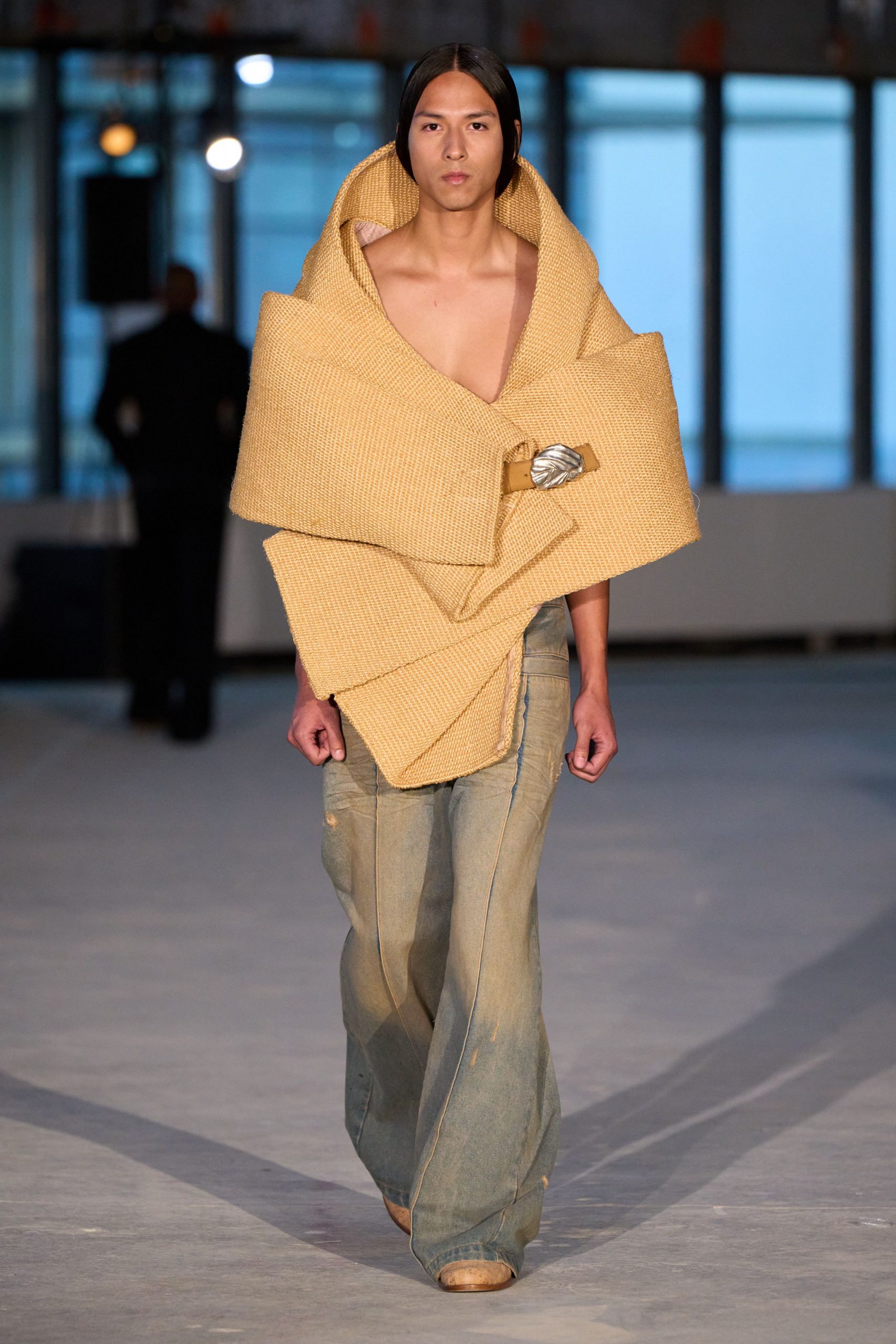 yellow draped coat with blue pants