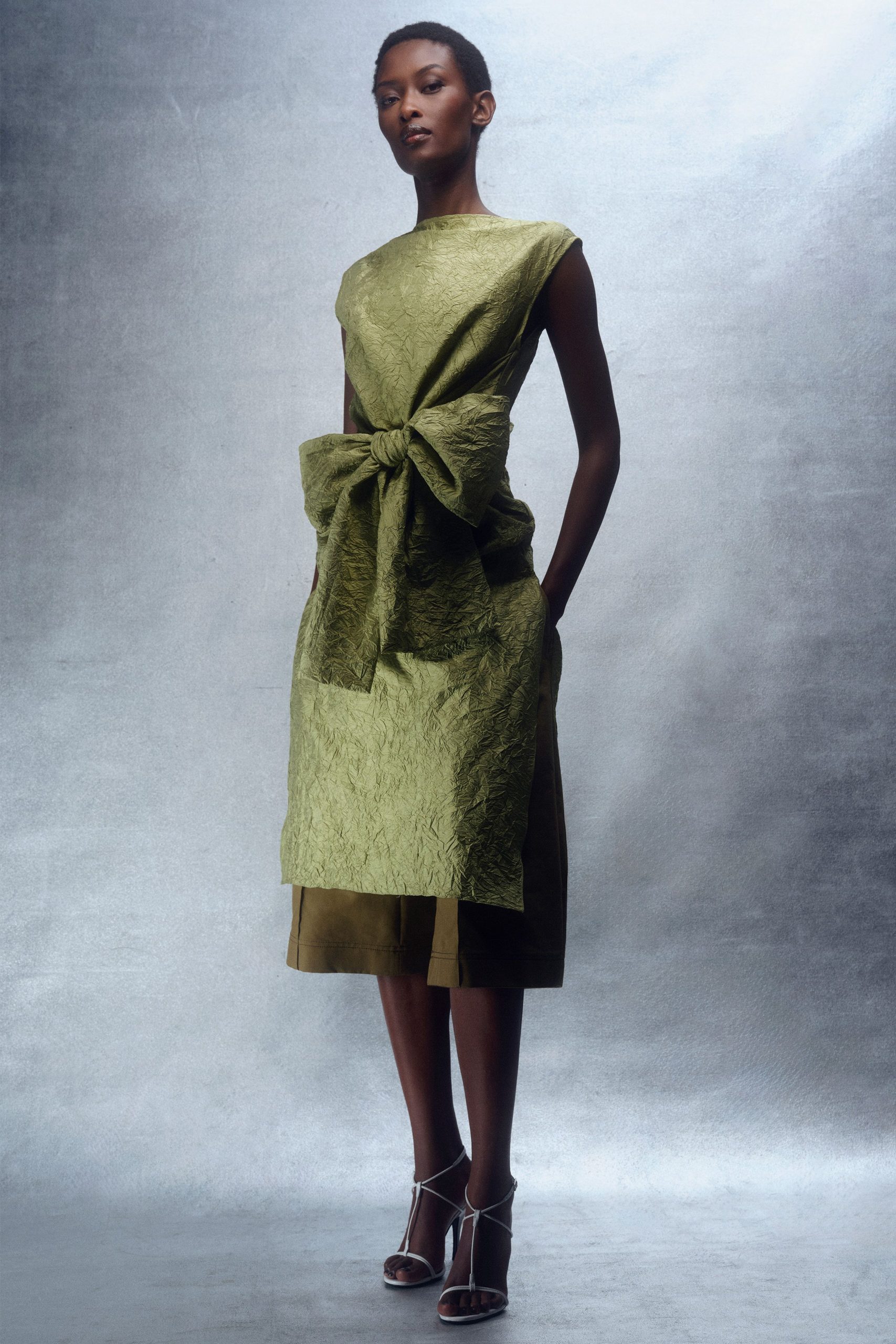 green silk sleeveless high-neck fitted belted draped dress