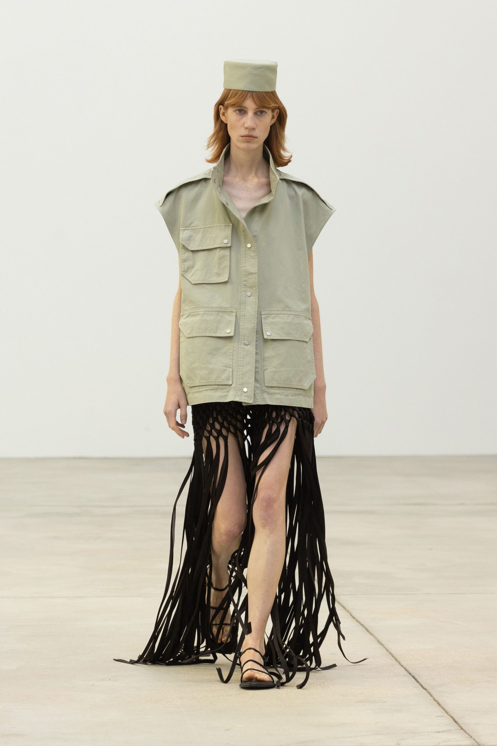 green cotton top with black fringed skirt