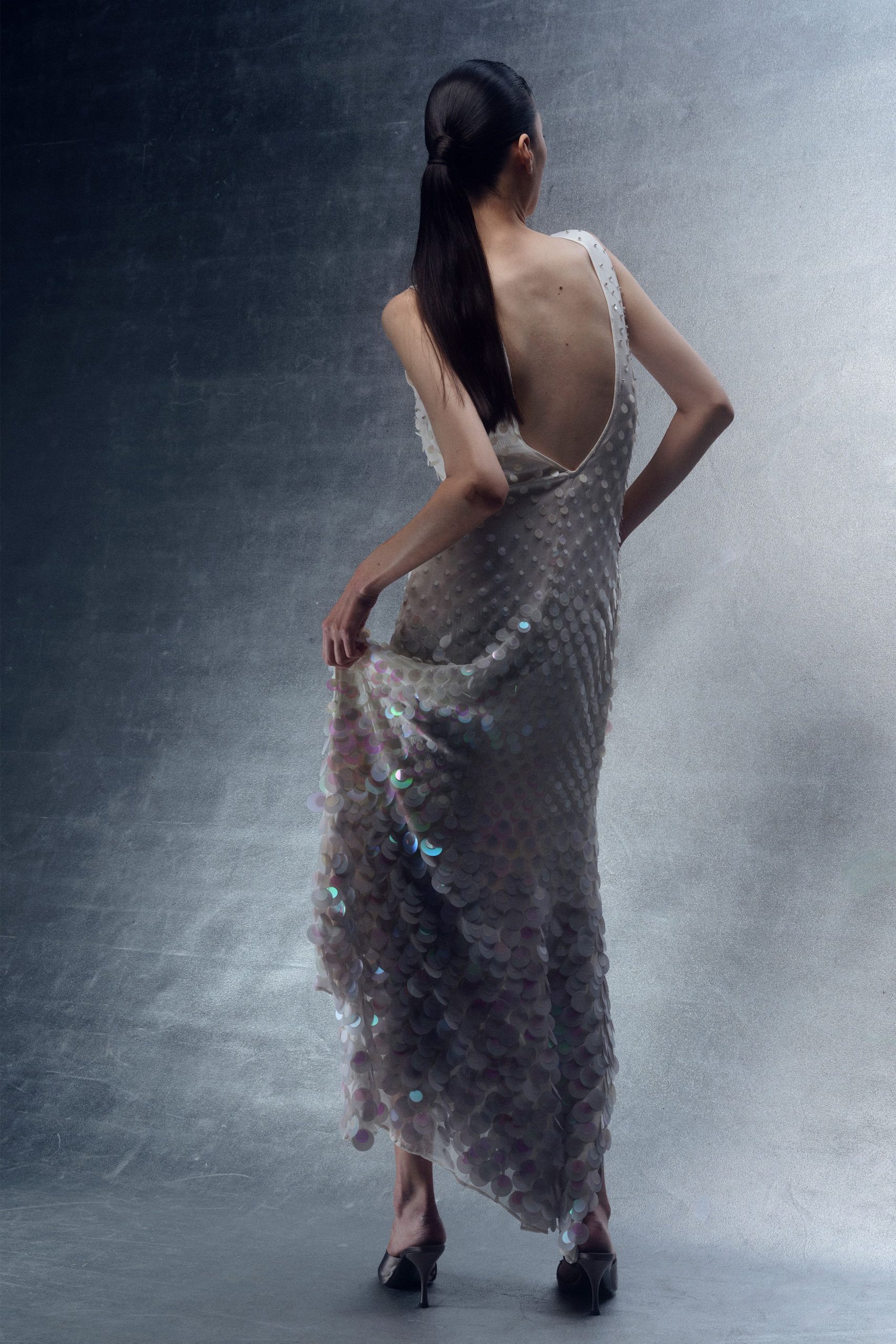 white silk sleeveless backless fitted layered embellished gown