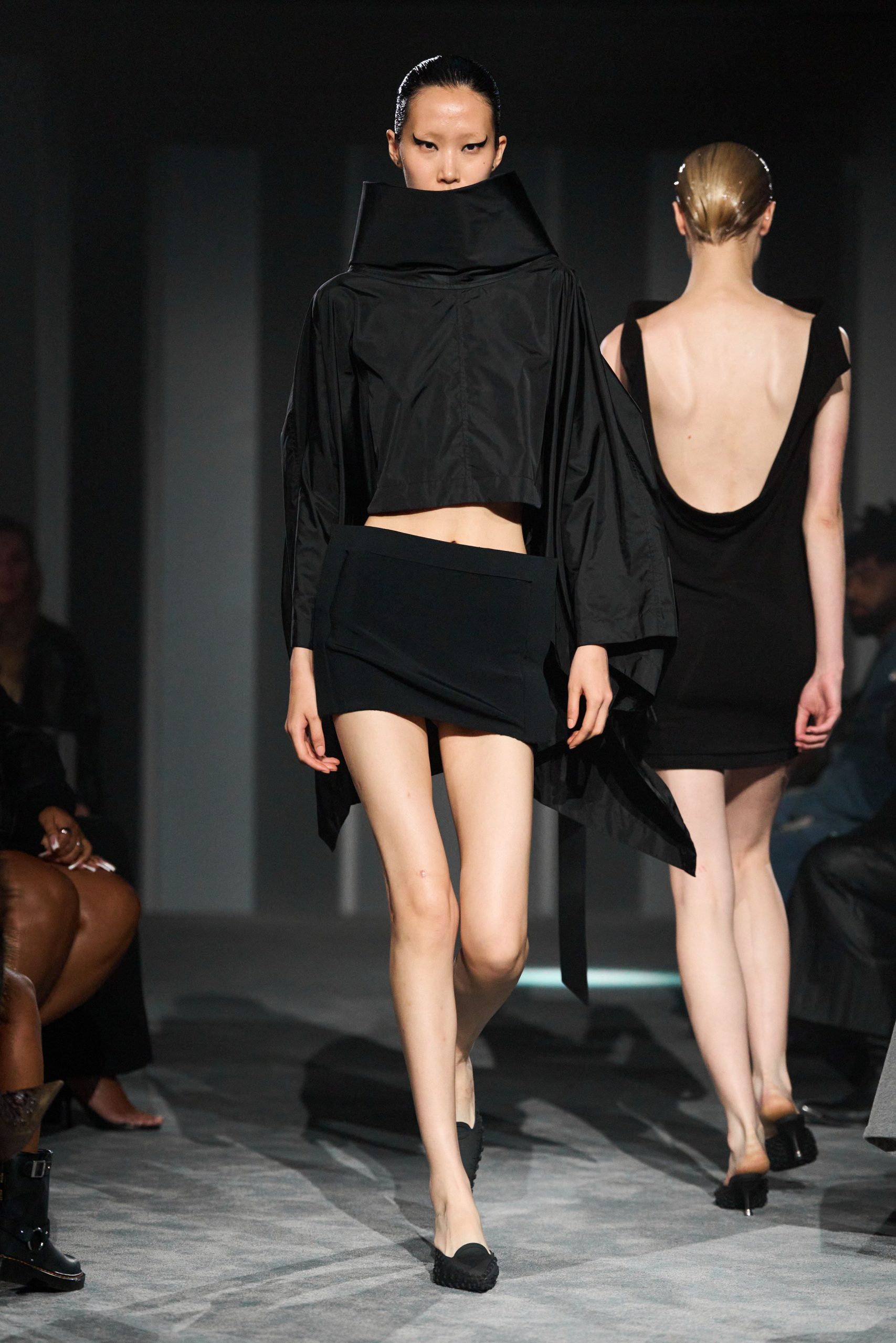 black fitted top and mini skirt
