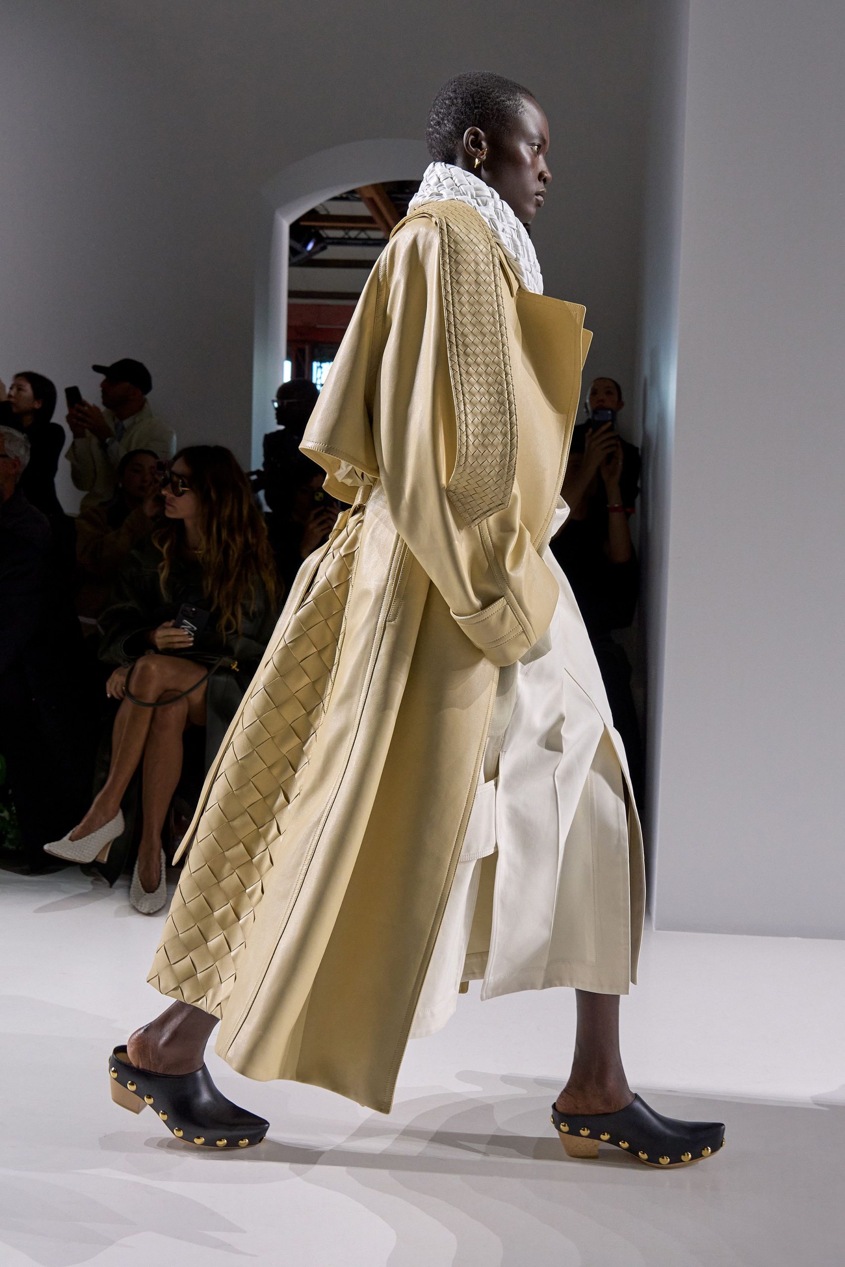 beige coat white pants black shoes