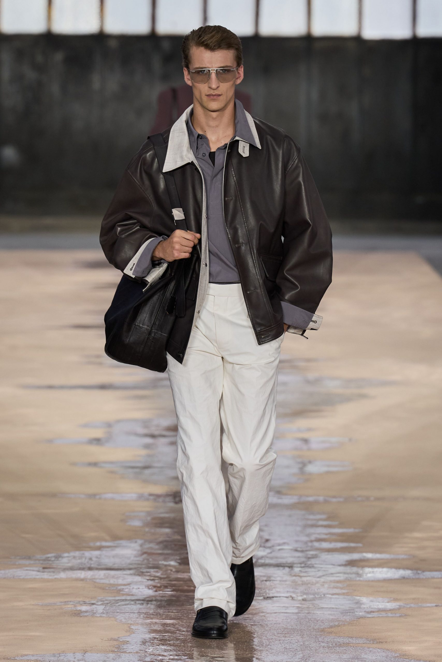 brown leather jacket gray shirt white pants