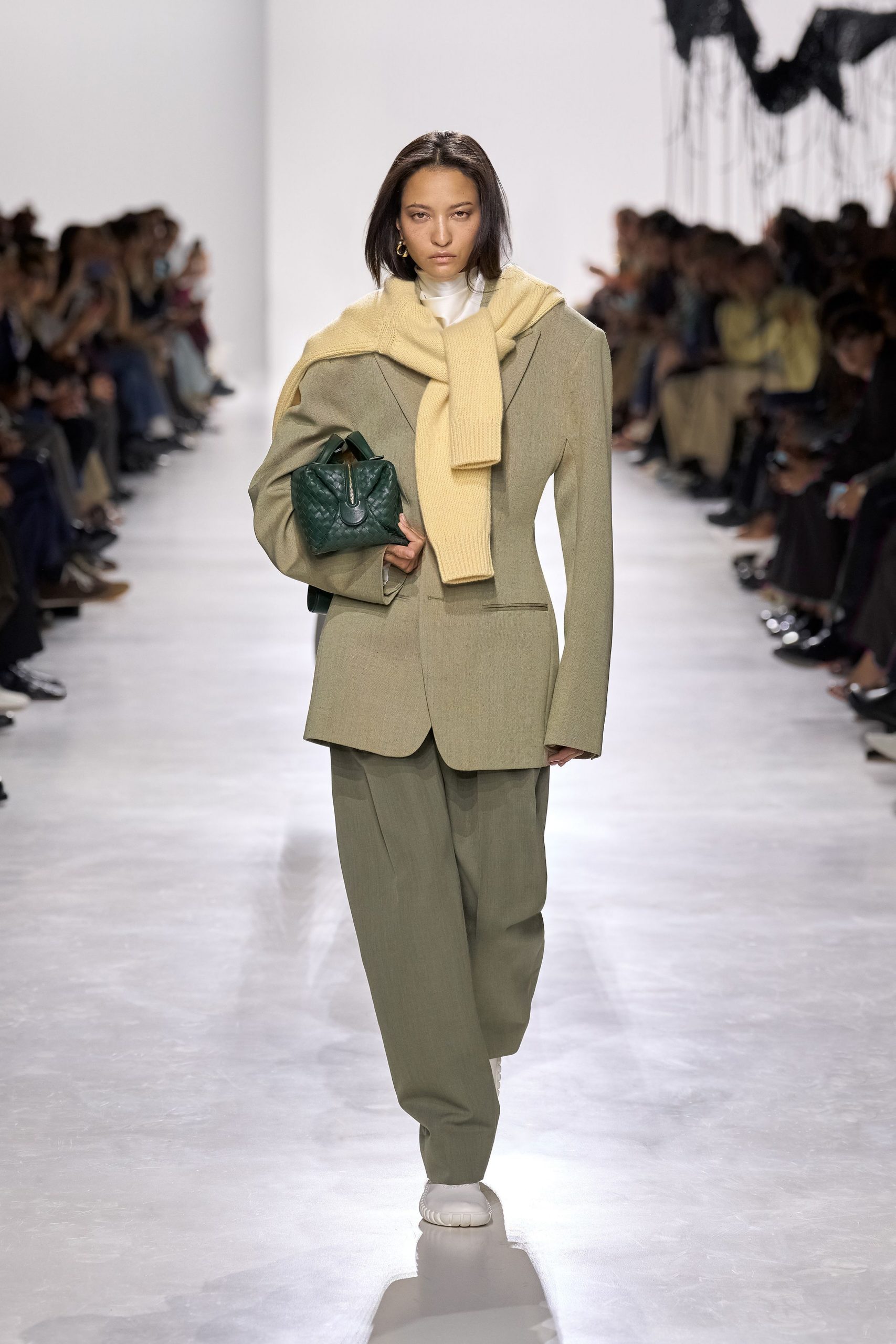 green tailored blazer with beige sweater