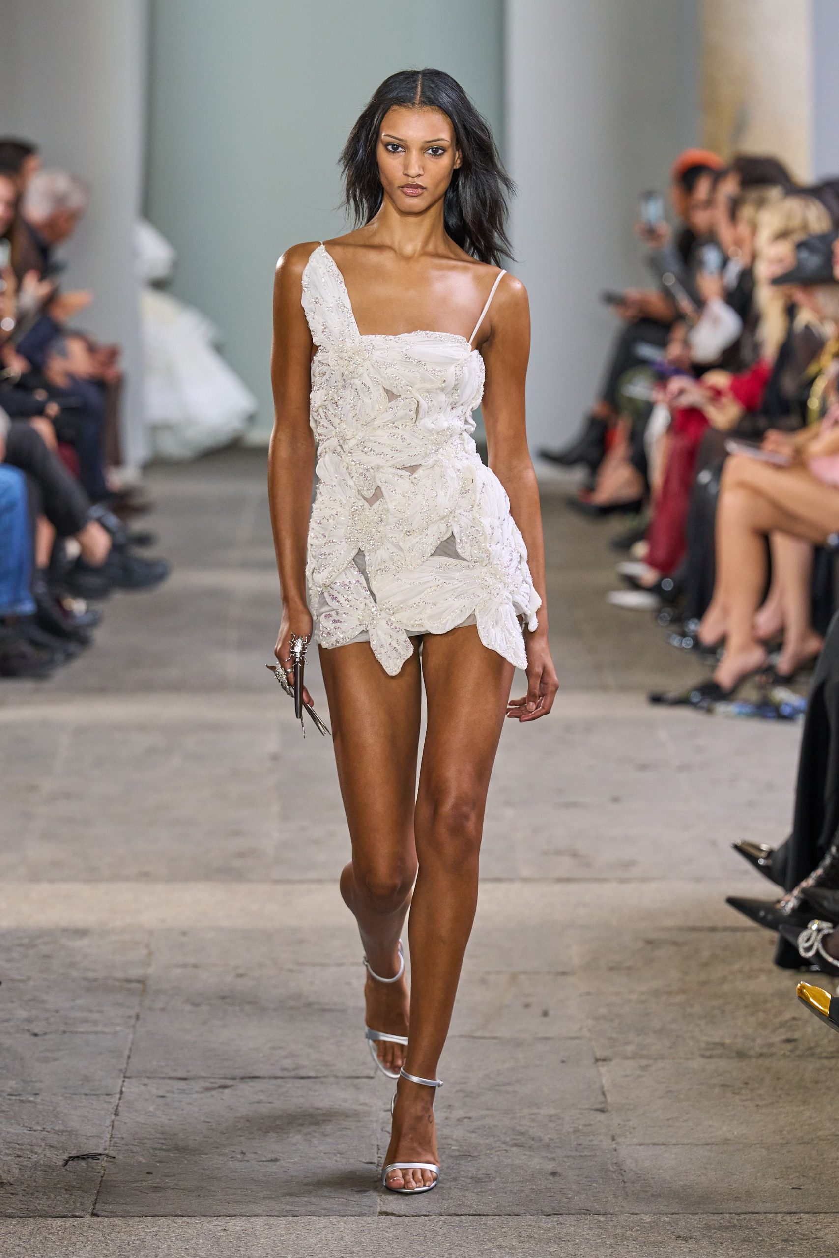 white lace mini dress with silver shoes