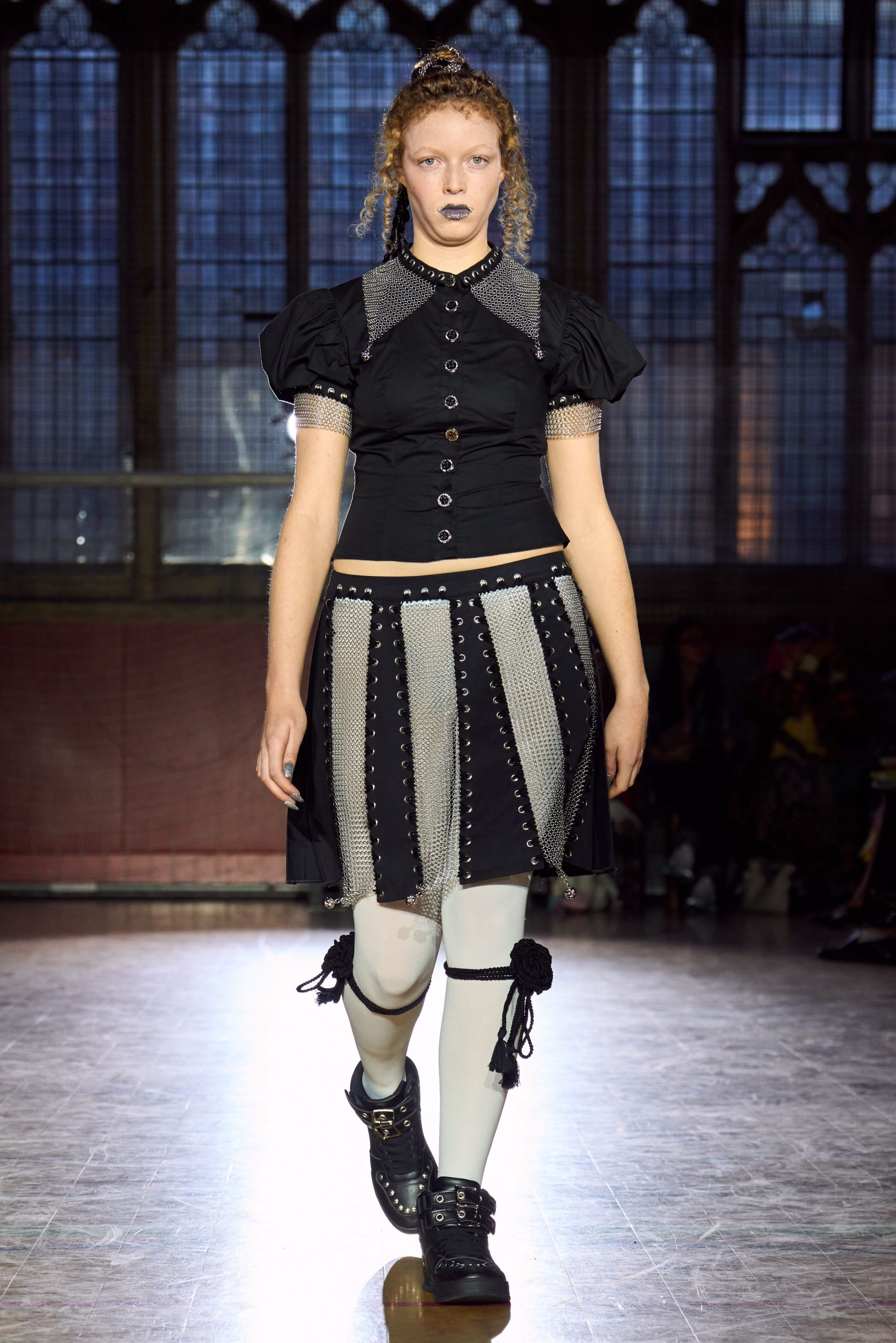 black fitted top and pleated skirt
