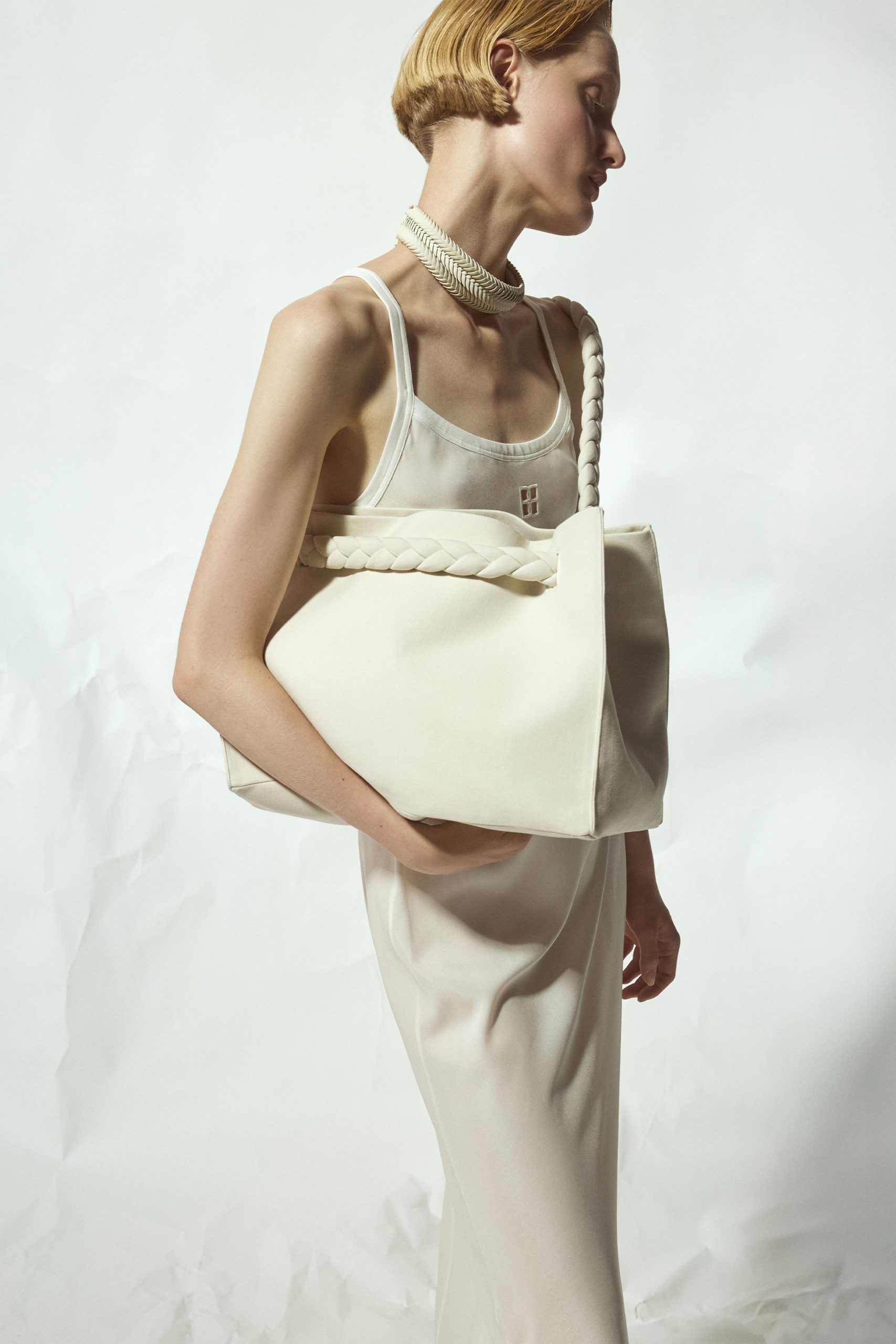 white fitted midi dress with beige bag