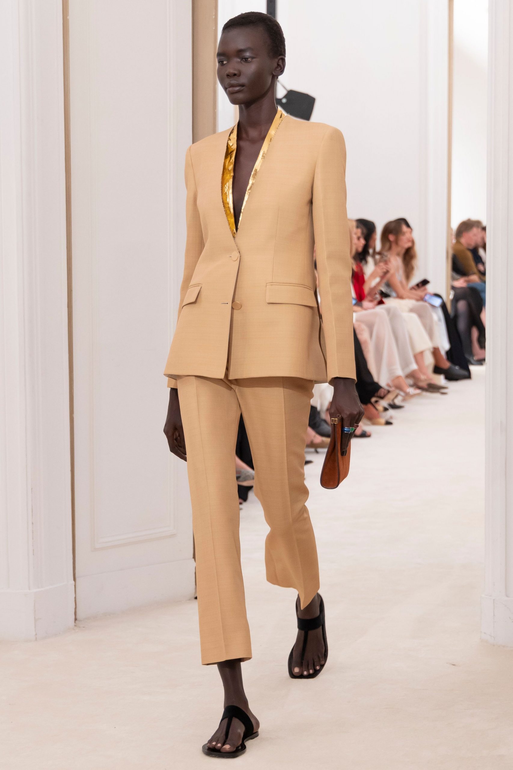beige tailored suit with black shoes