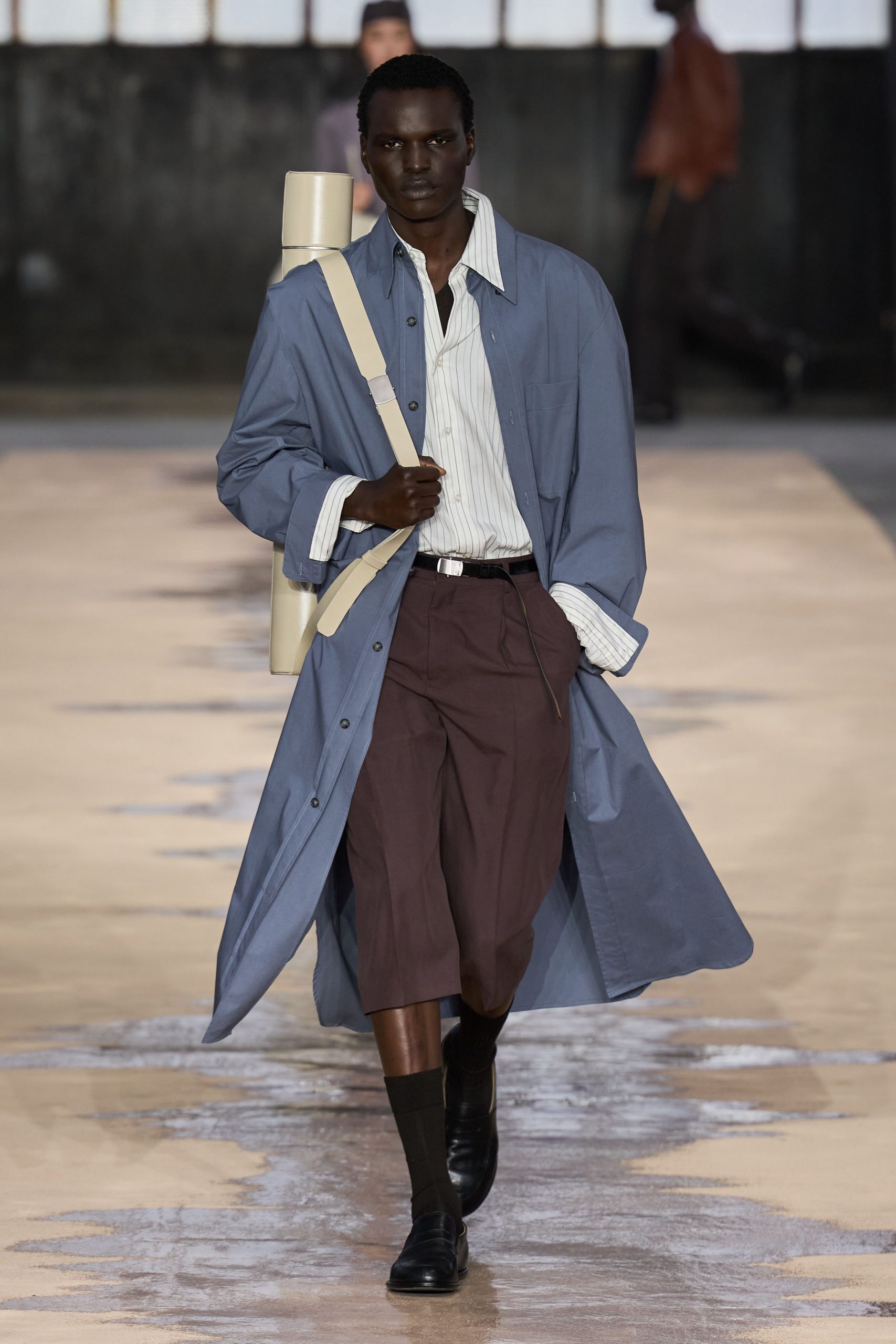 blue coat white shirt brown shorts