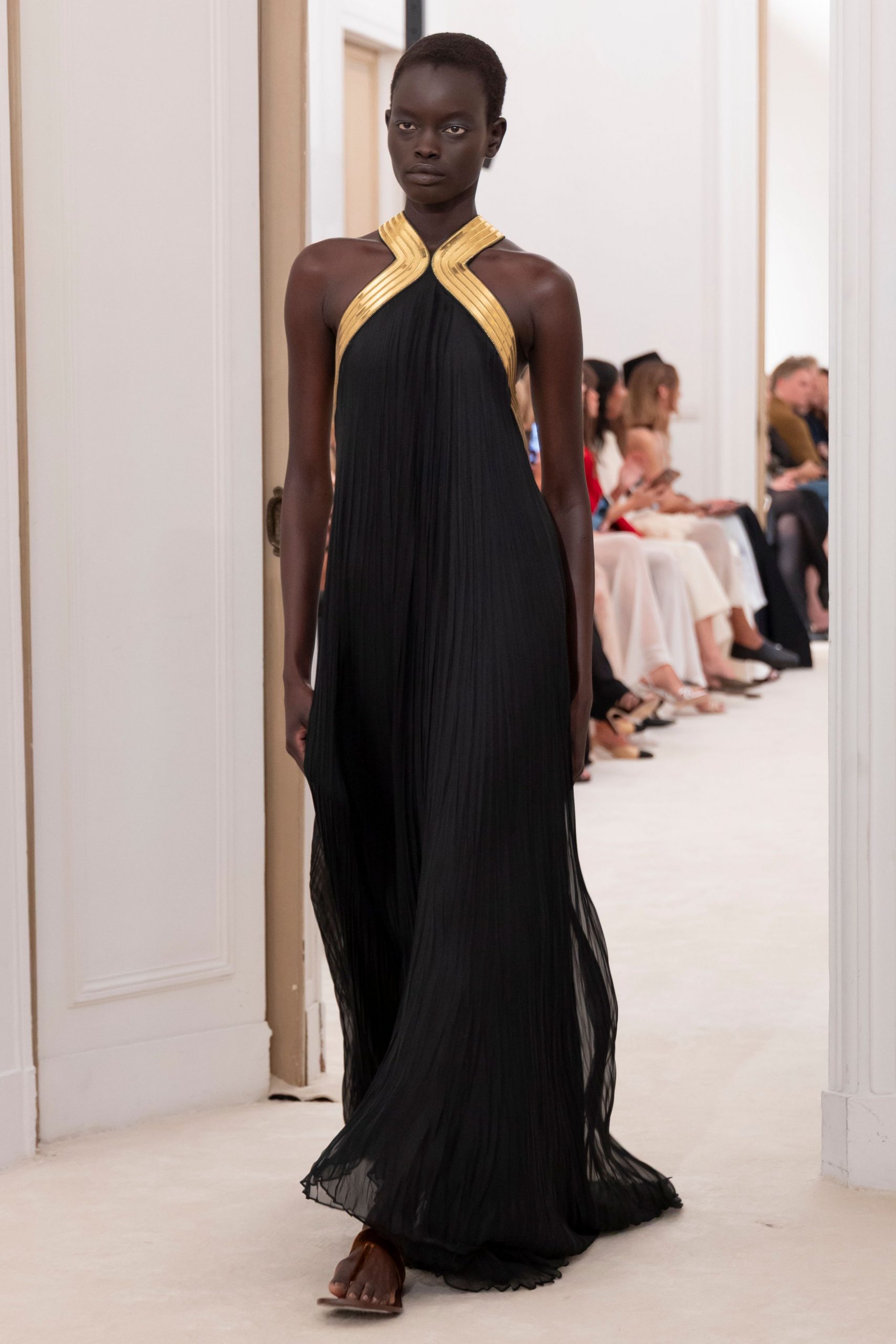 black pleated halter gown with sandals