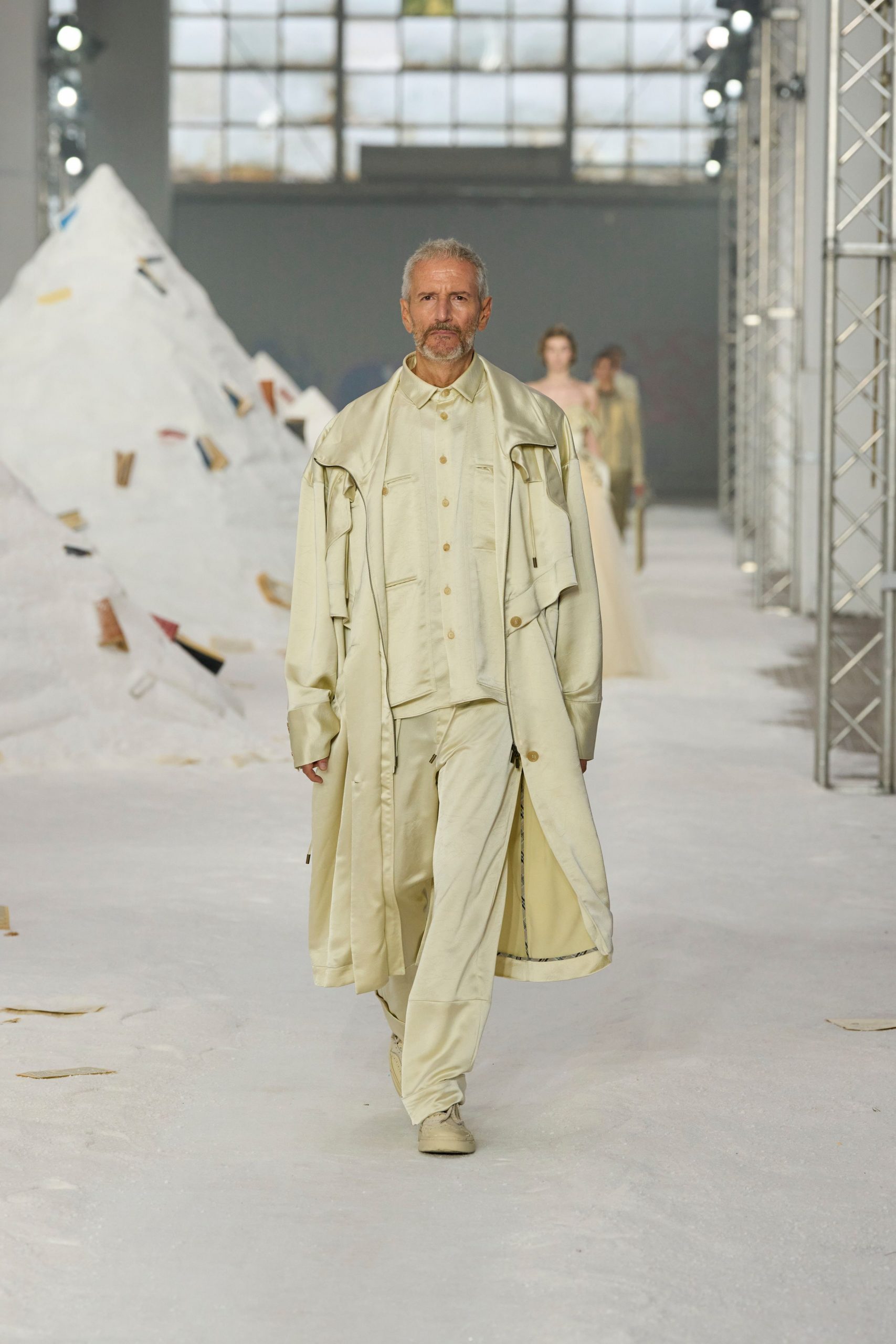 beige relaxed coat with fitted shirt and pants