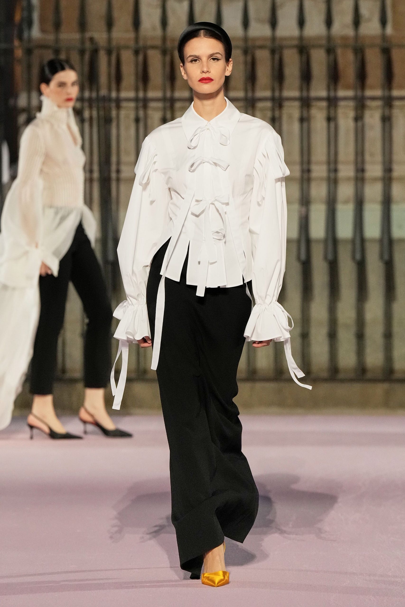 white ruffled blouse with black tailored pants