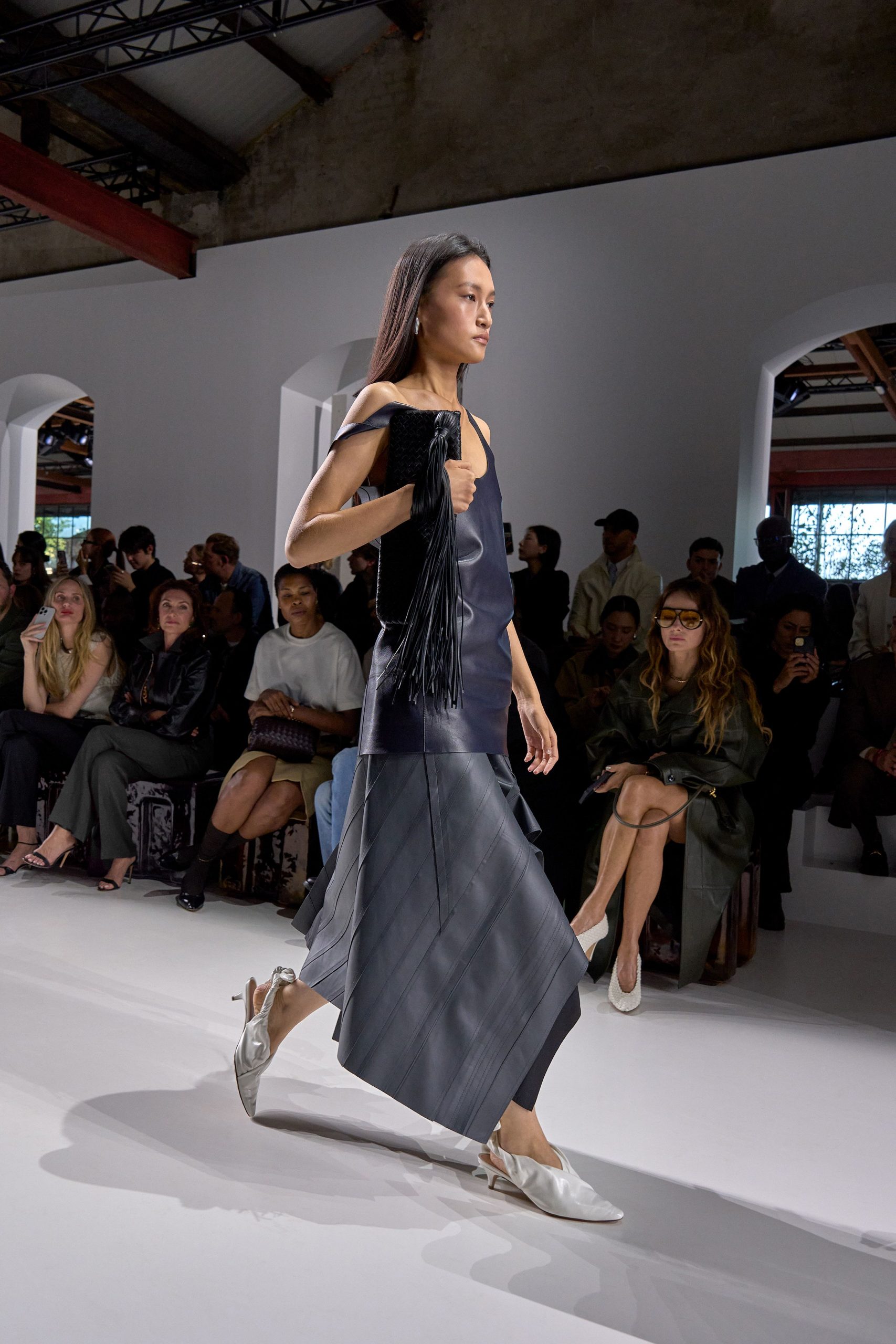 black leather sleeveless dress with white shoes