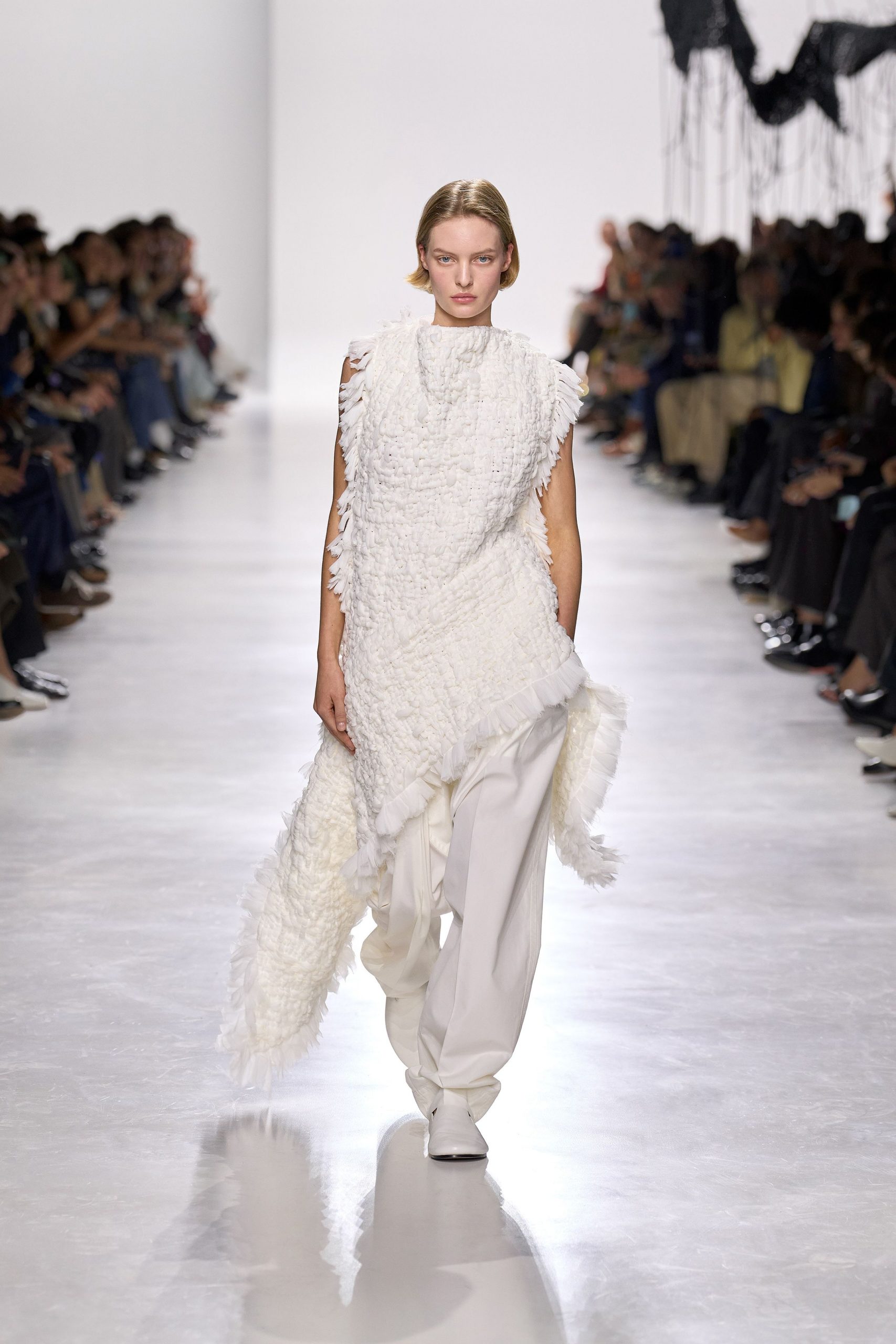 white ruffled top with relaxed pants