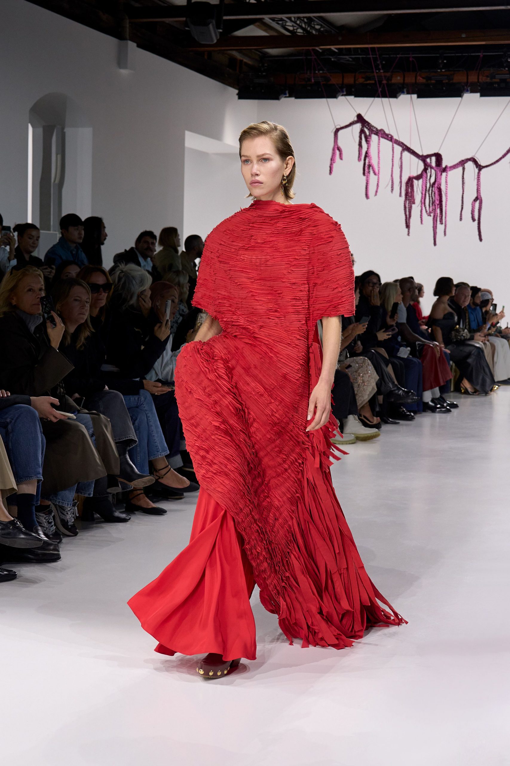 red pleated flowing gown