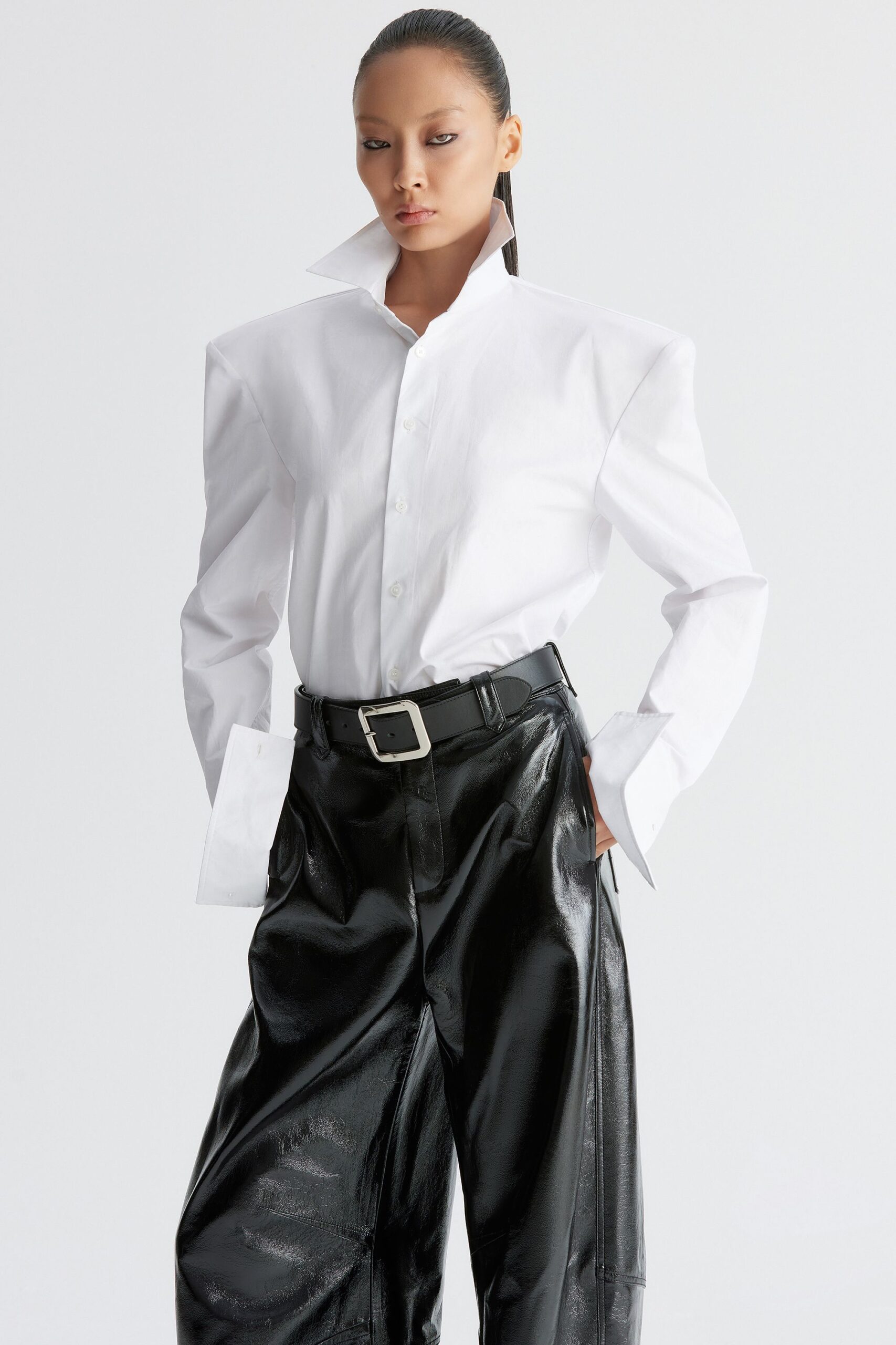 structured white shirt with black leather pants