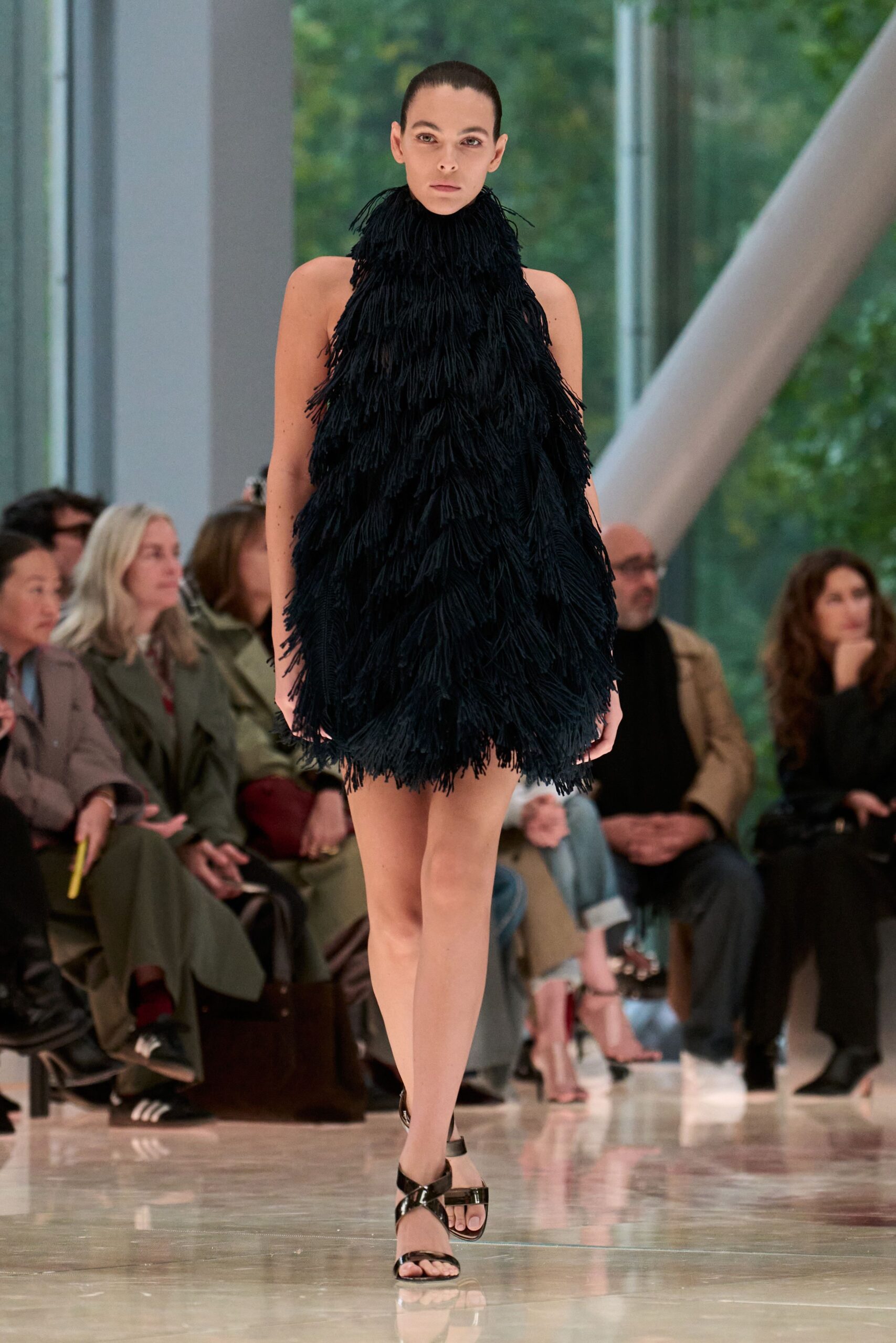 black fringed mini dress with strappy shoes
