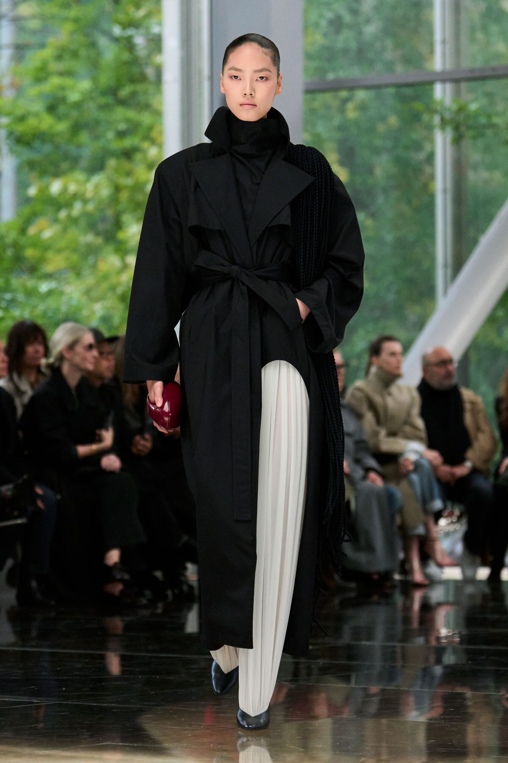 black coat white pants red bag