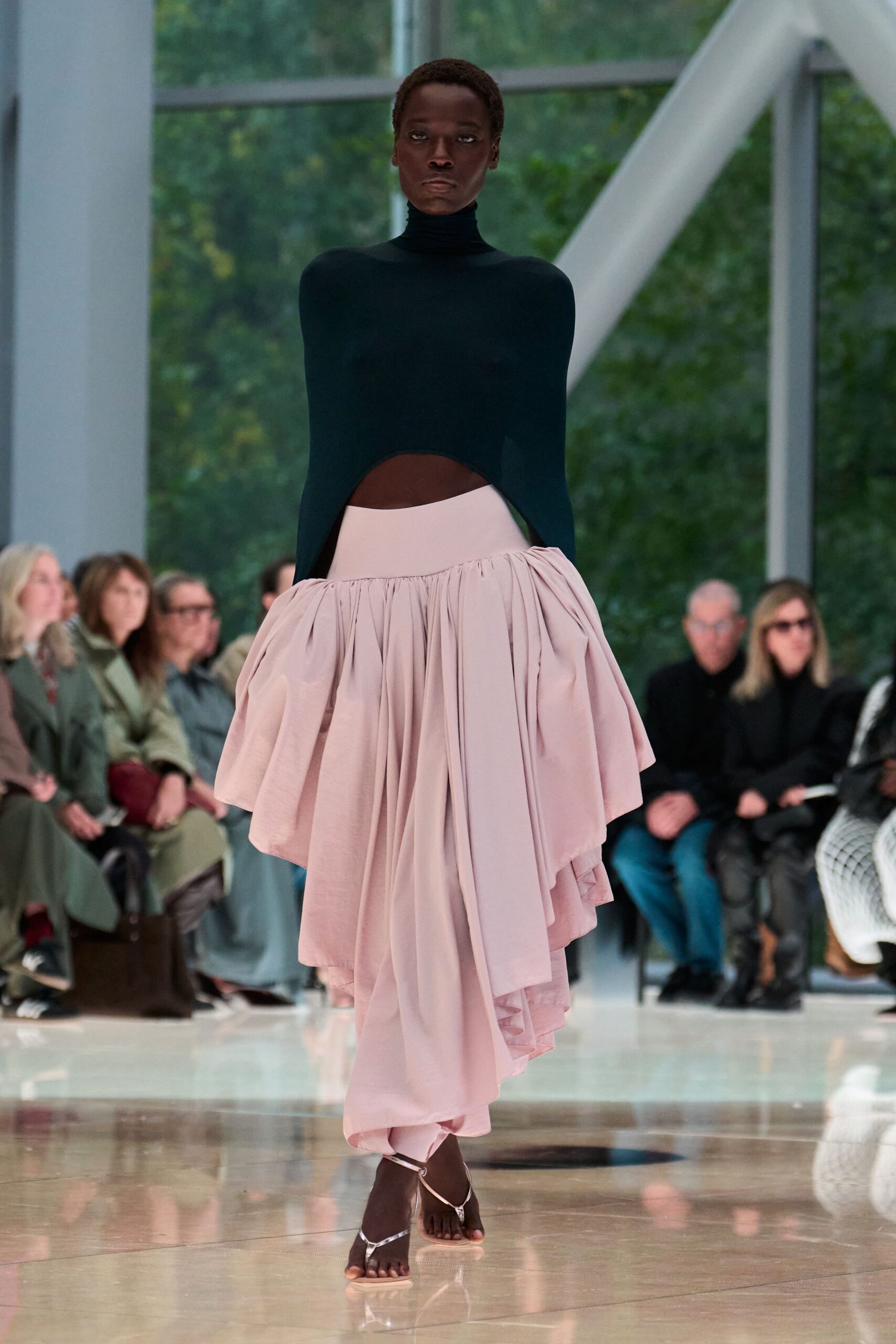green fitted top with cutout and pink pleated skirt