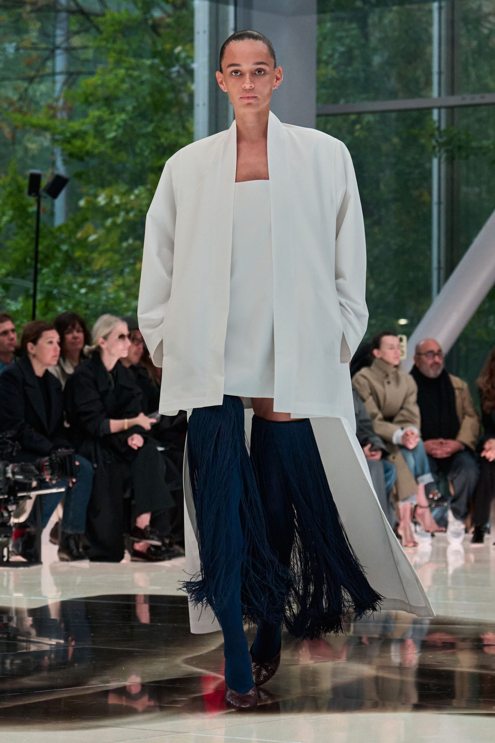 white oversized coat with blue fringed pants