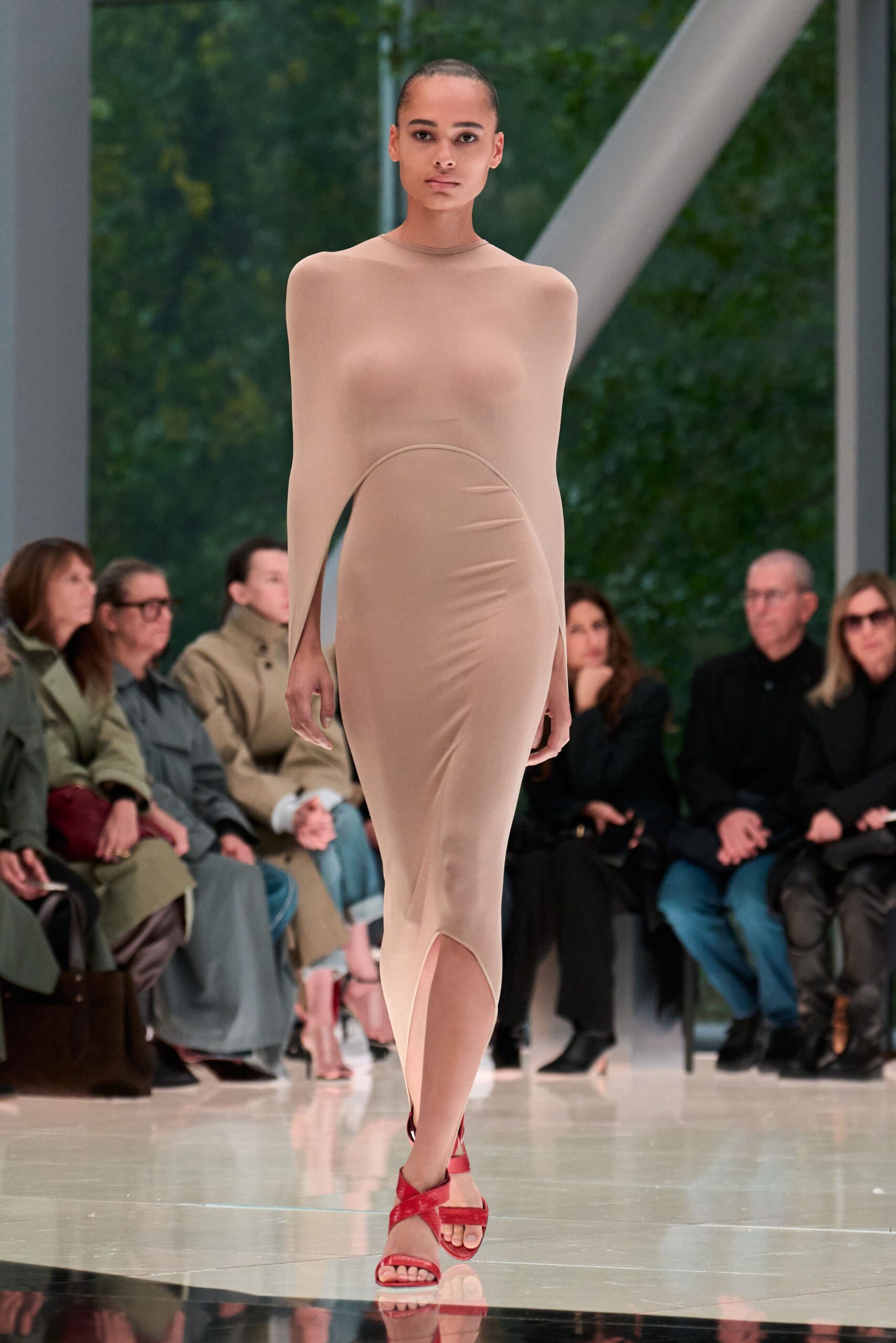 beige fitted midi dress with red shoes
