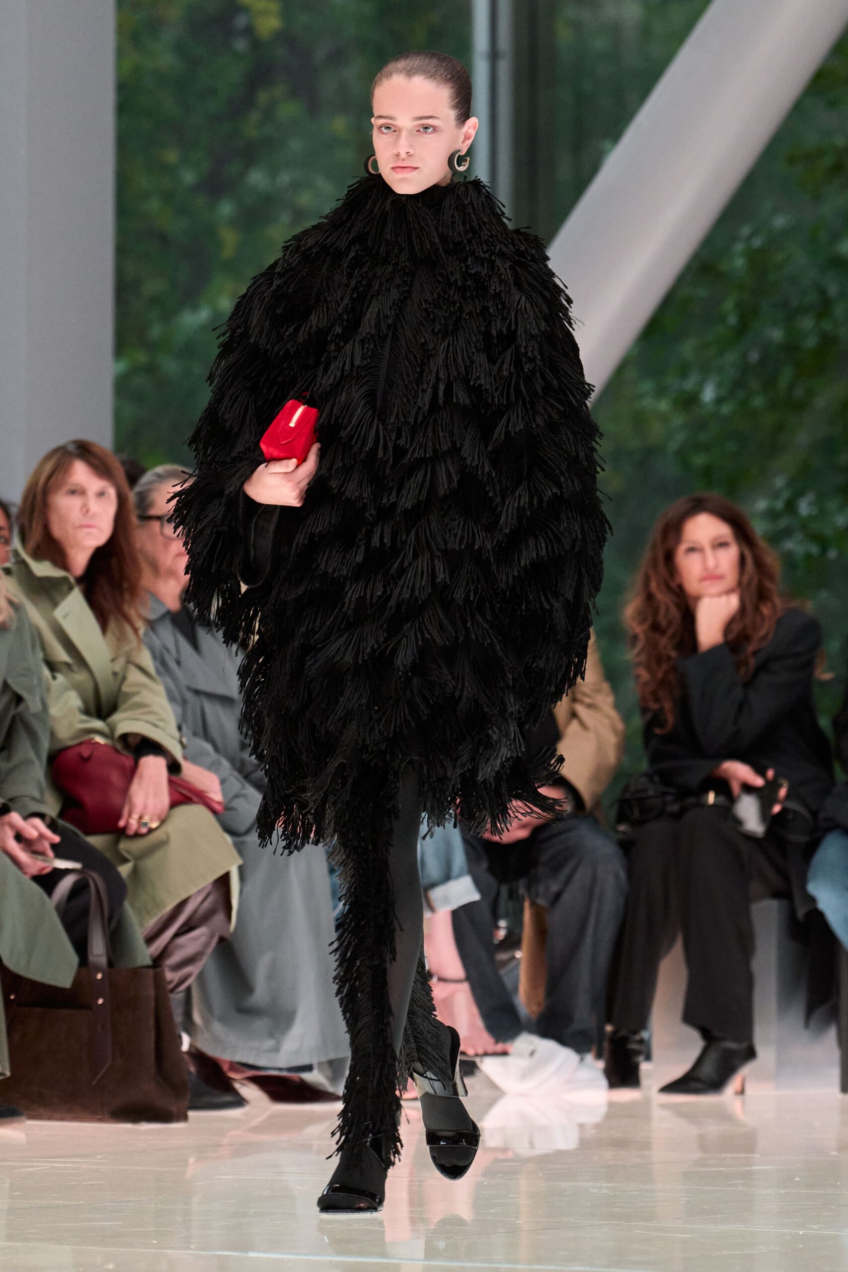black fringed coat with red bag