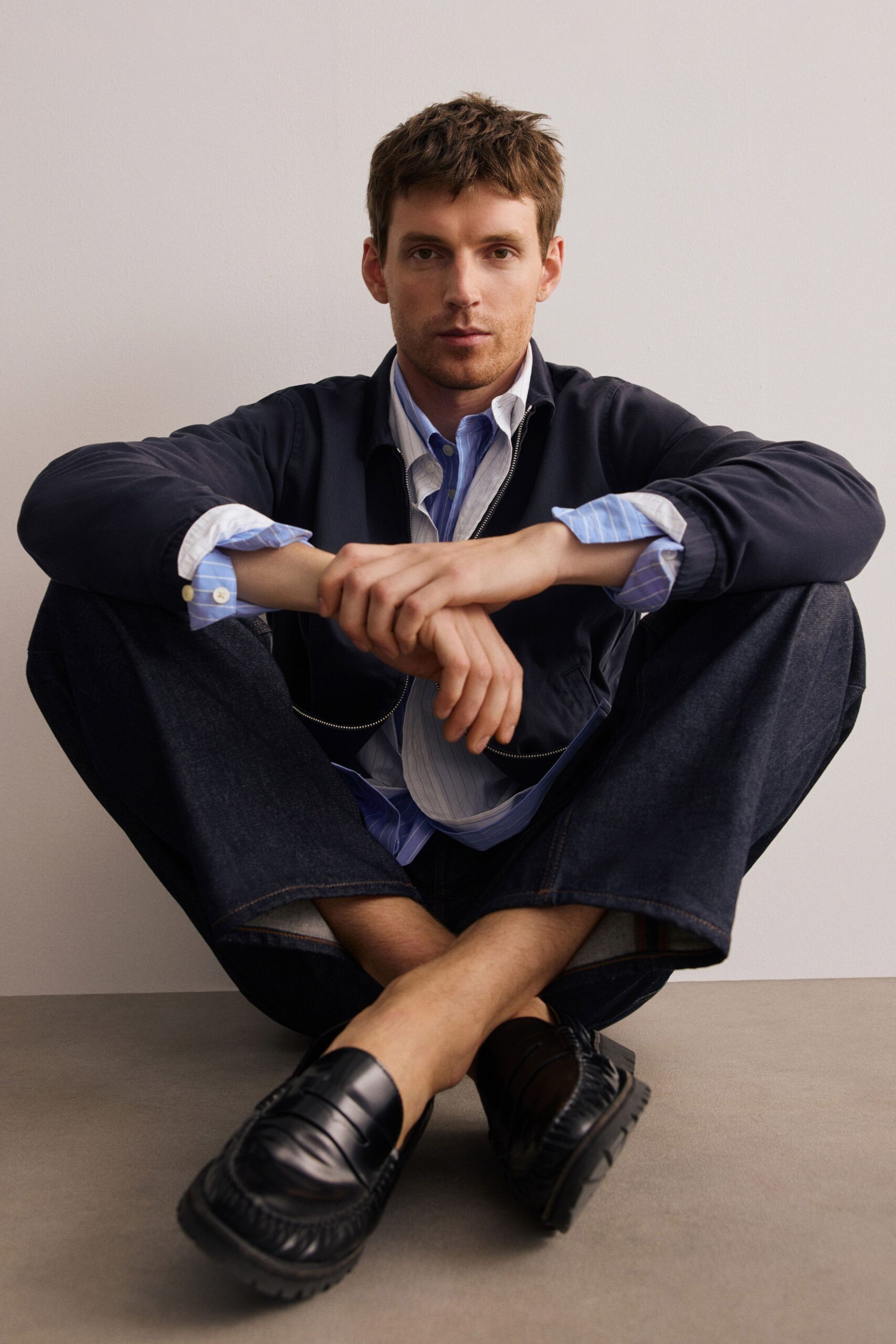 black jacket white shirt blue pants