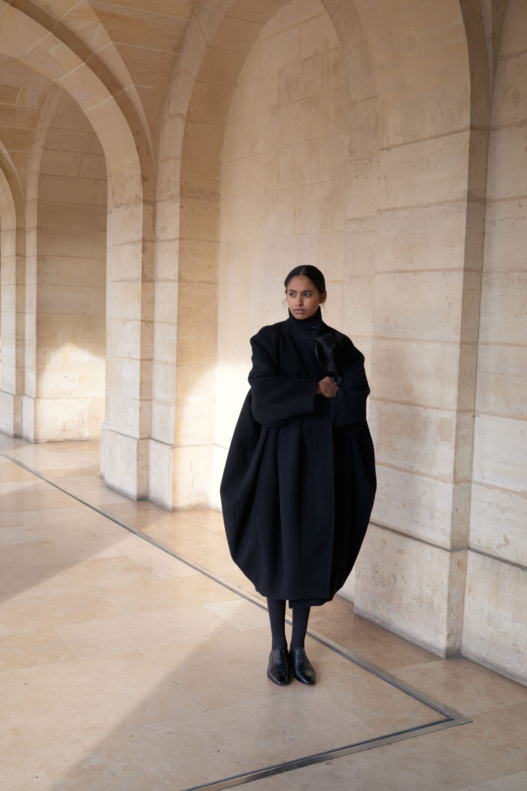 black wool long-sleeve collared oversized draped coat