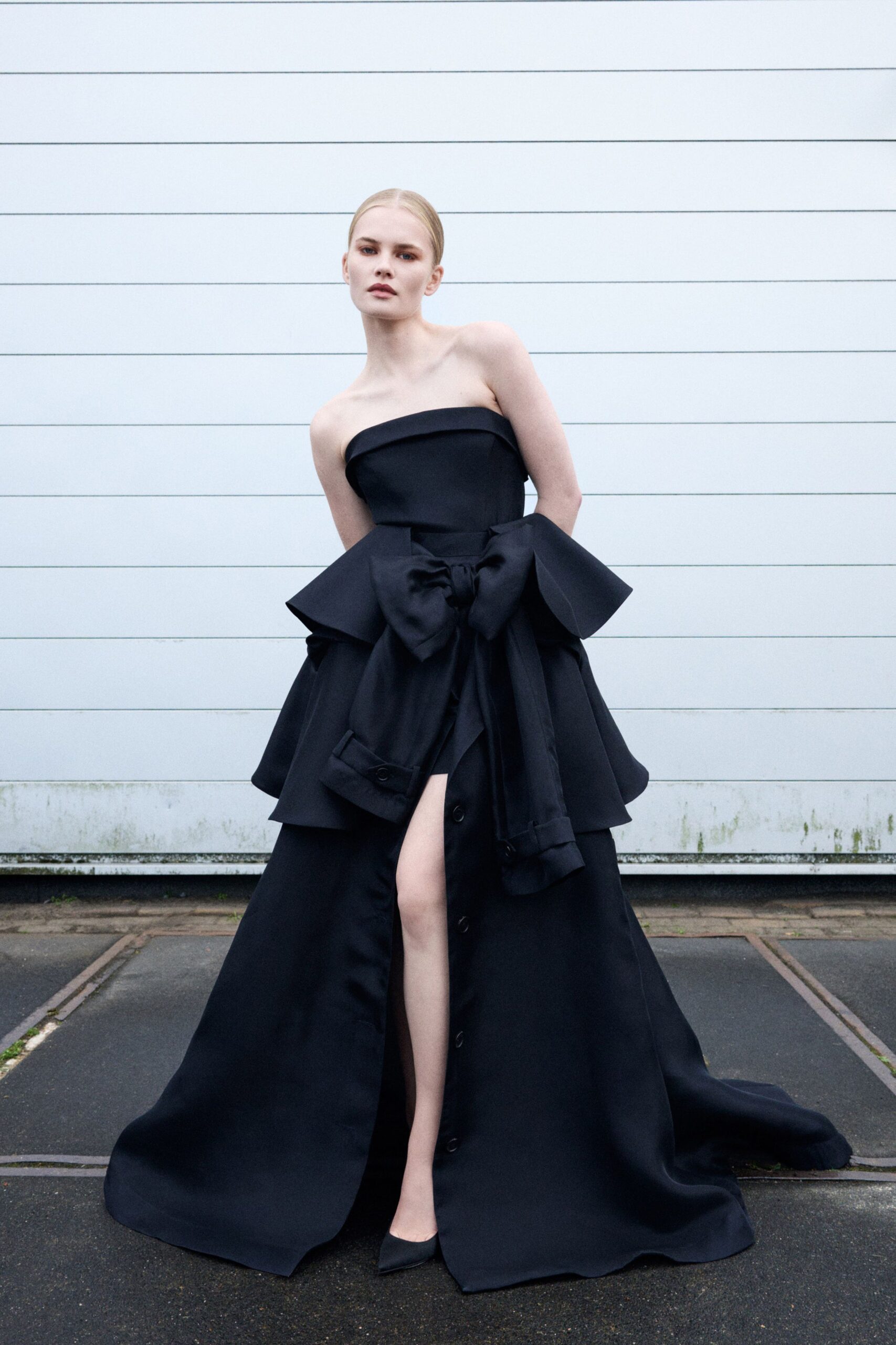 black silk strapless long-sleeve fitted tiered buttoned gown