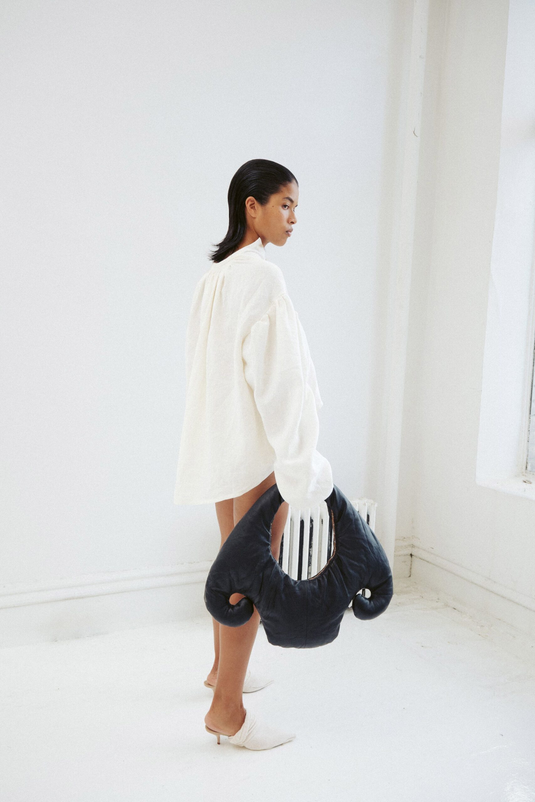 white relaxed jacket with black bag