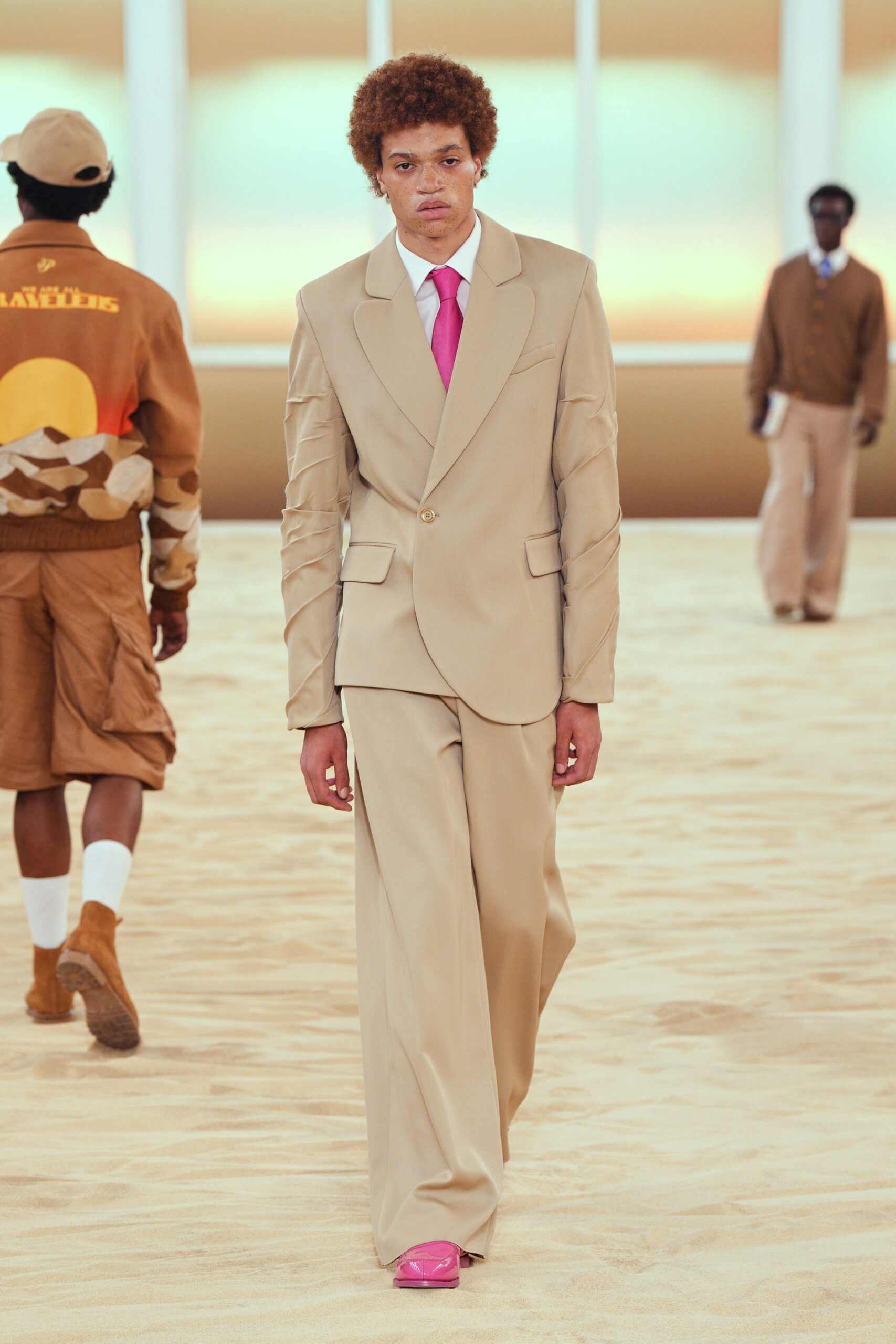 beige tailored suit with pink tie