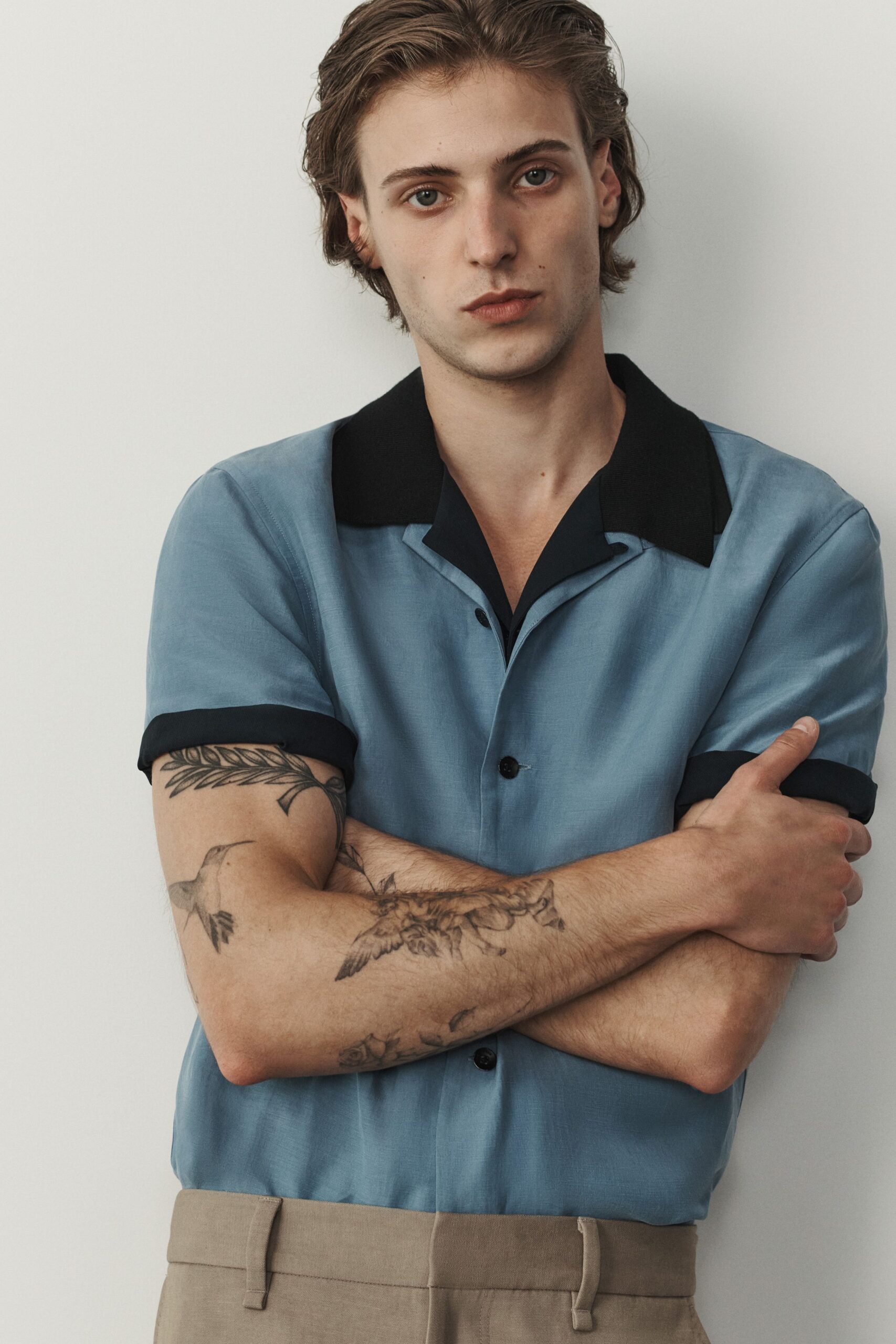 blue silk short-sleeve shirt and beige tailored pants