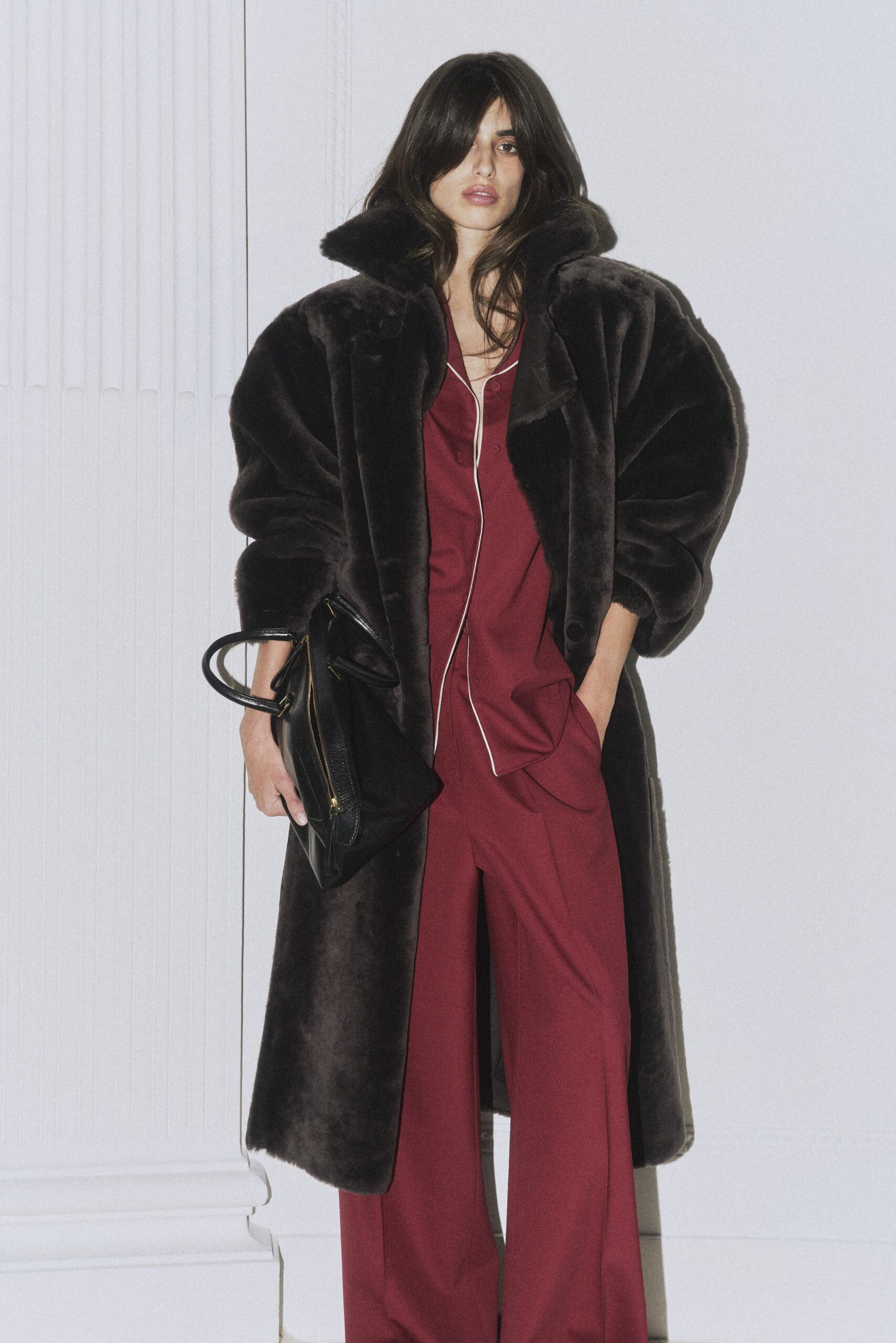 brown faux-fur coat with red jumpsuit