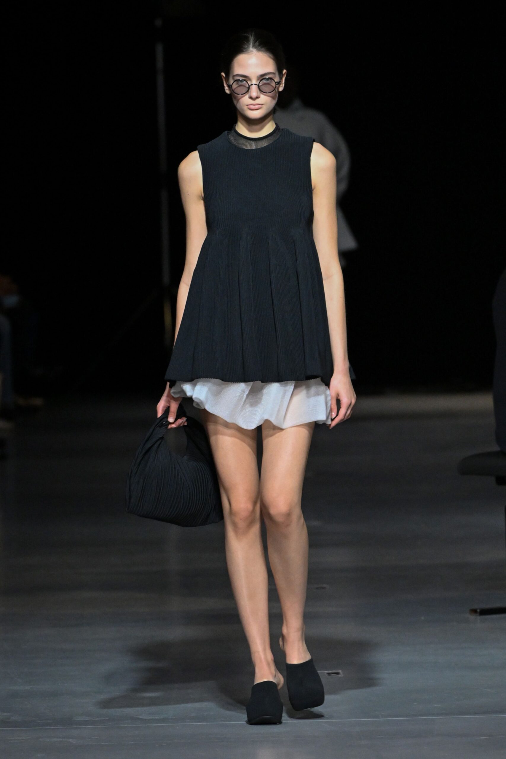 black relaxed top with white mini skirt