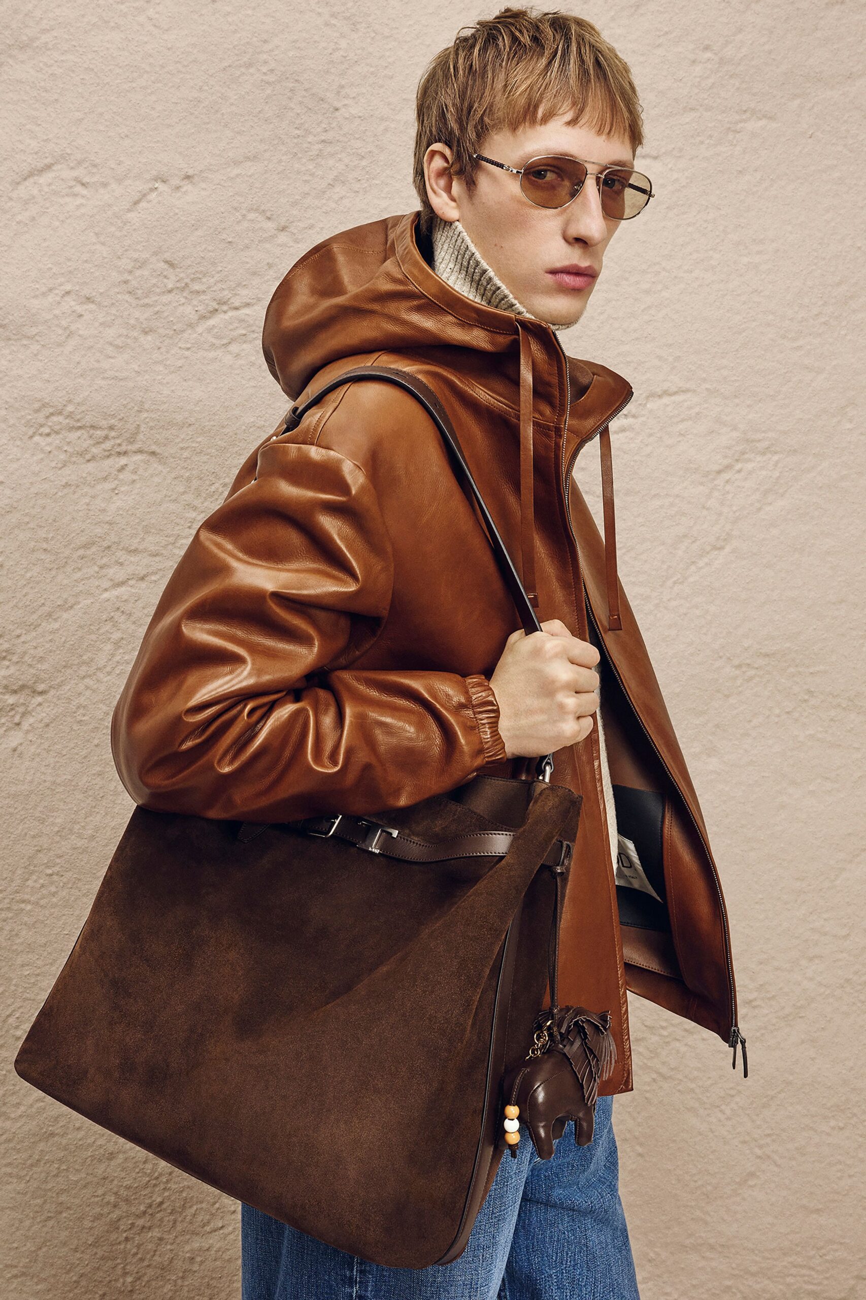 brown leather jacket with beige sweater