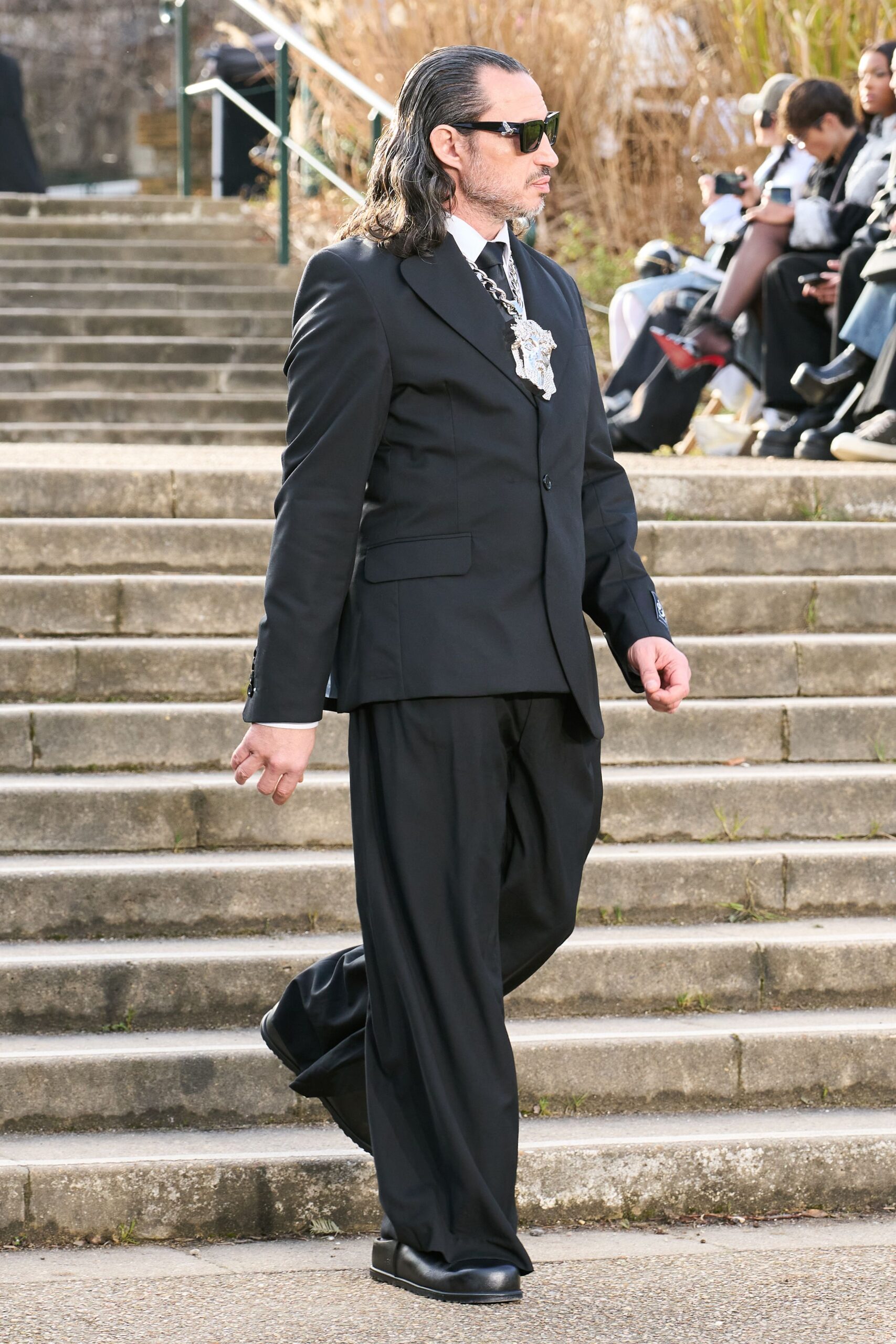 black tailored suit with embellished tie