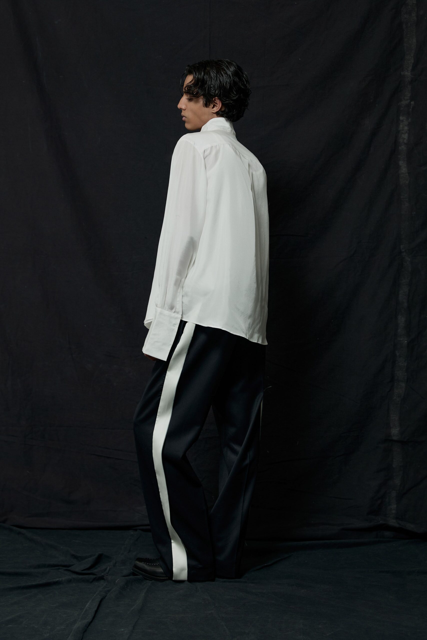 white silk relaxed shirt and black tailored pants