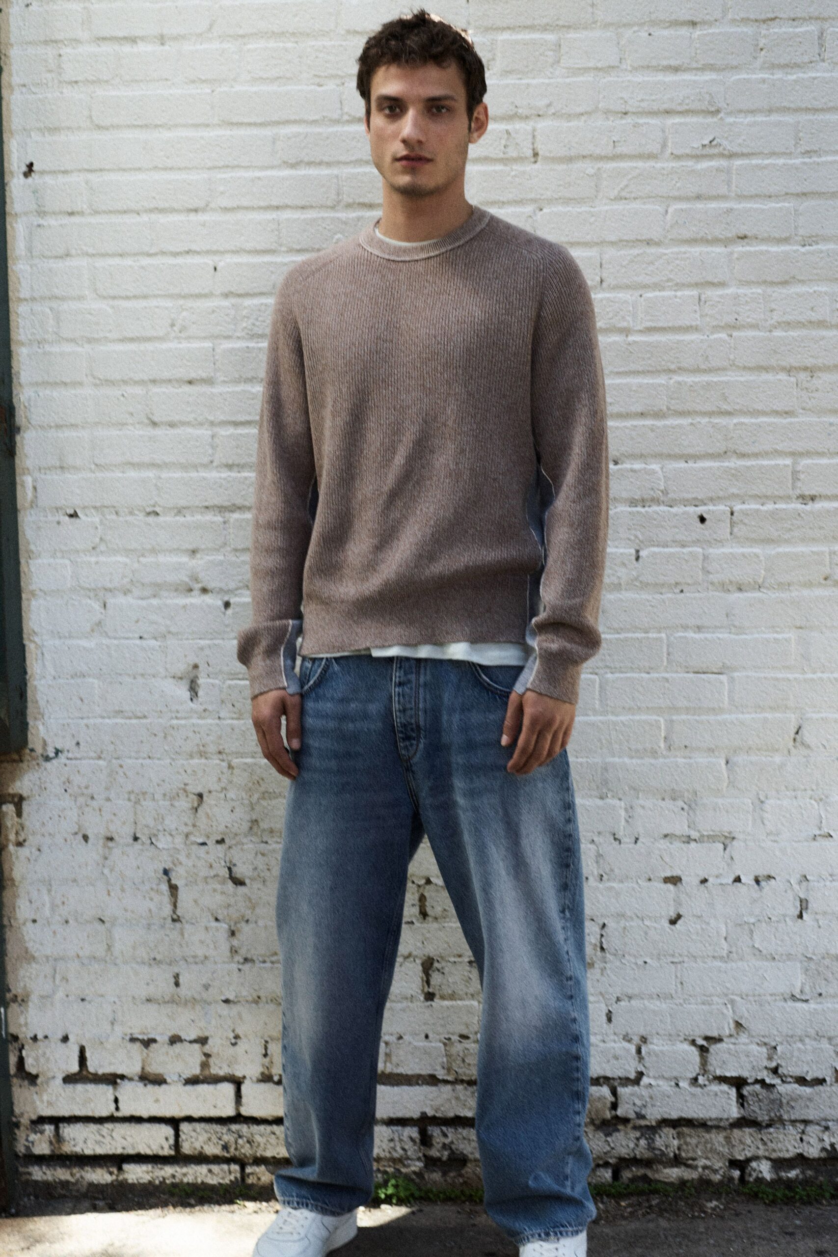 beige relaxed sweater with blue jeans