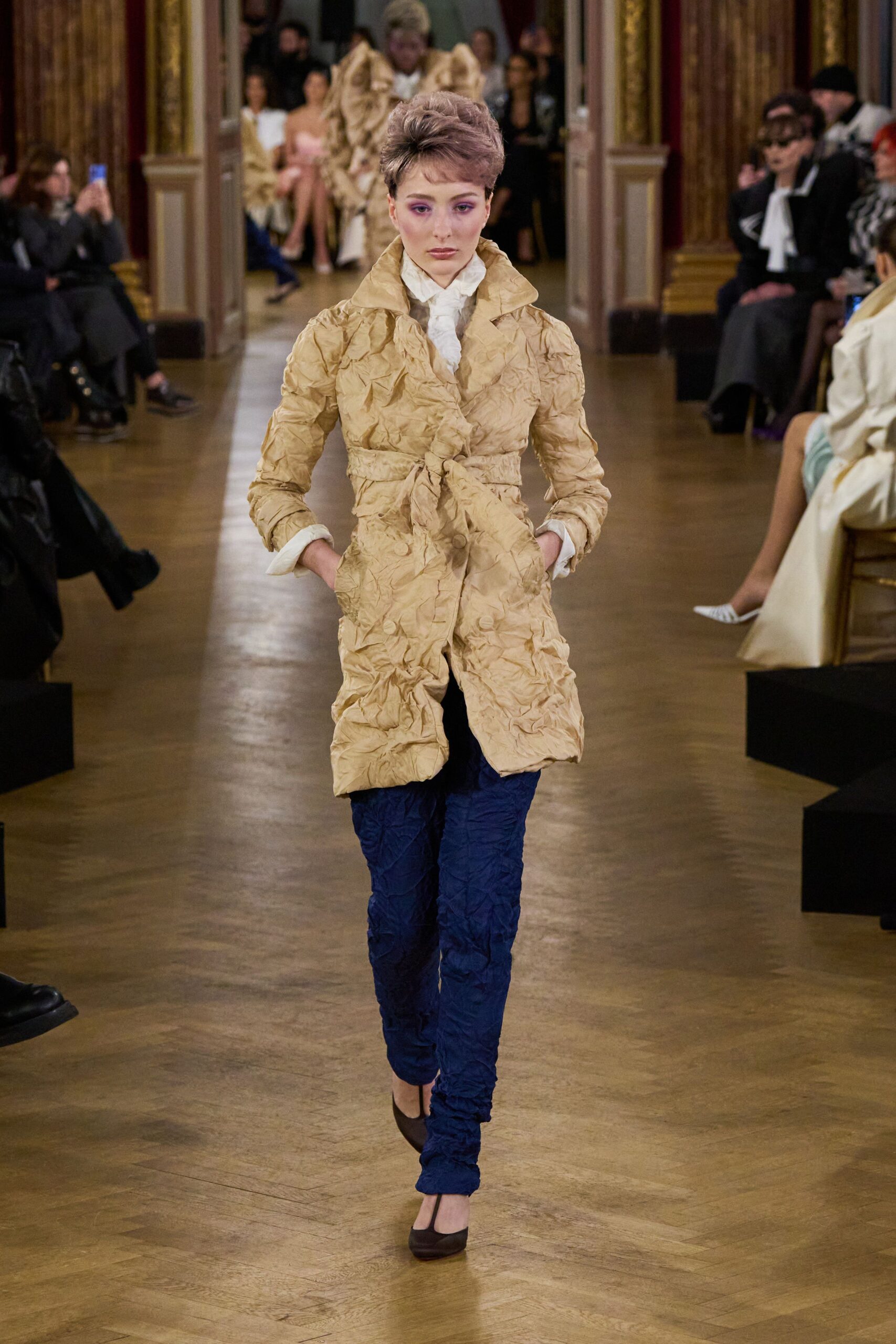 beige coat blue pants brown shoes