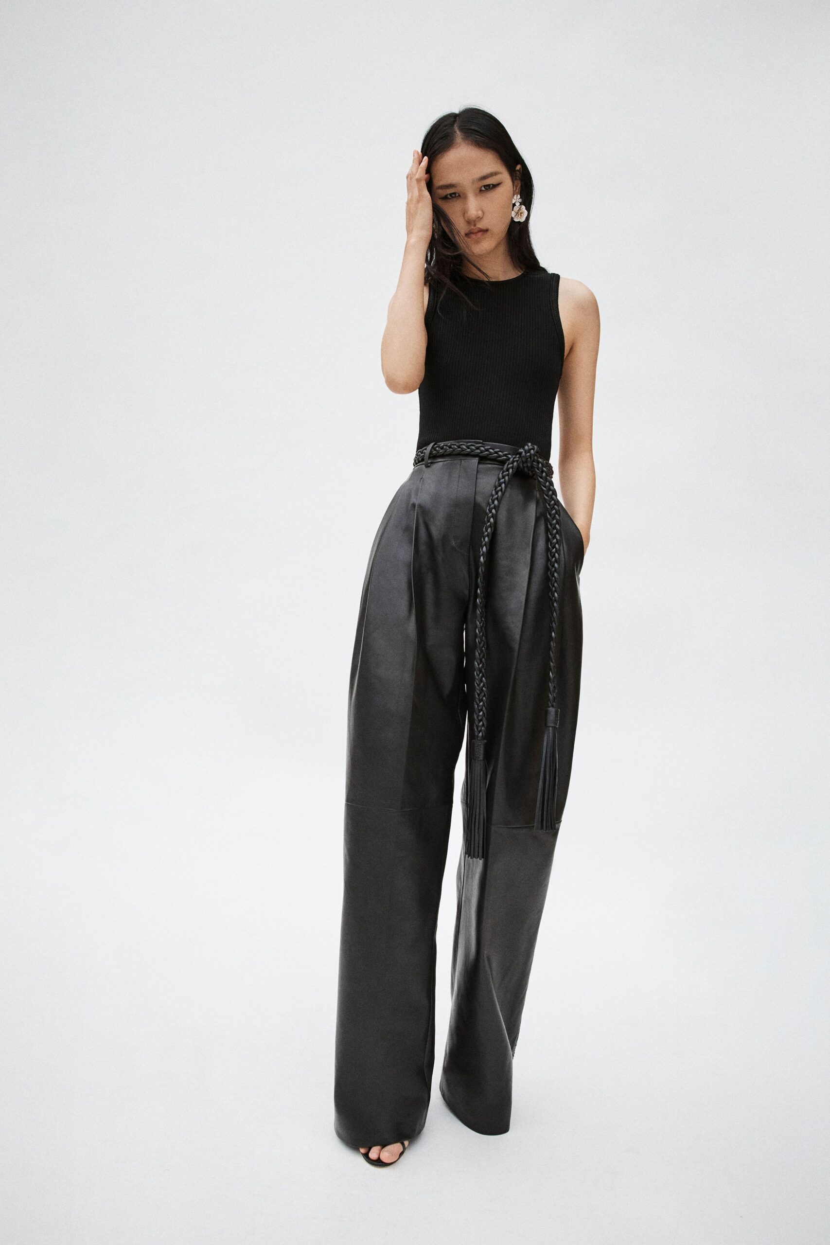 black fitted top and relaxed leather pants