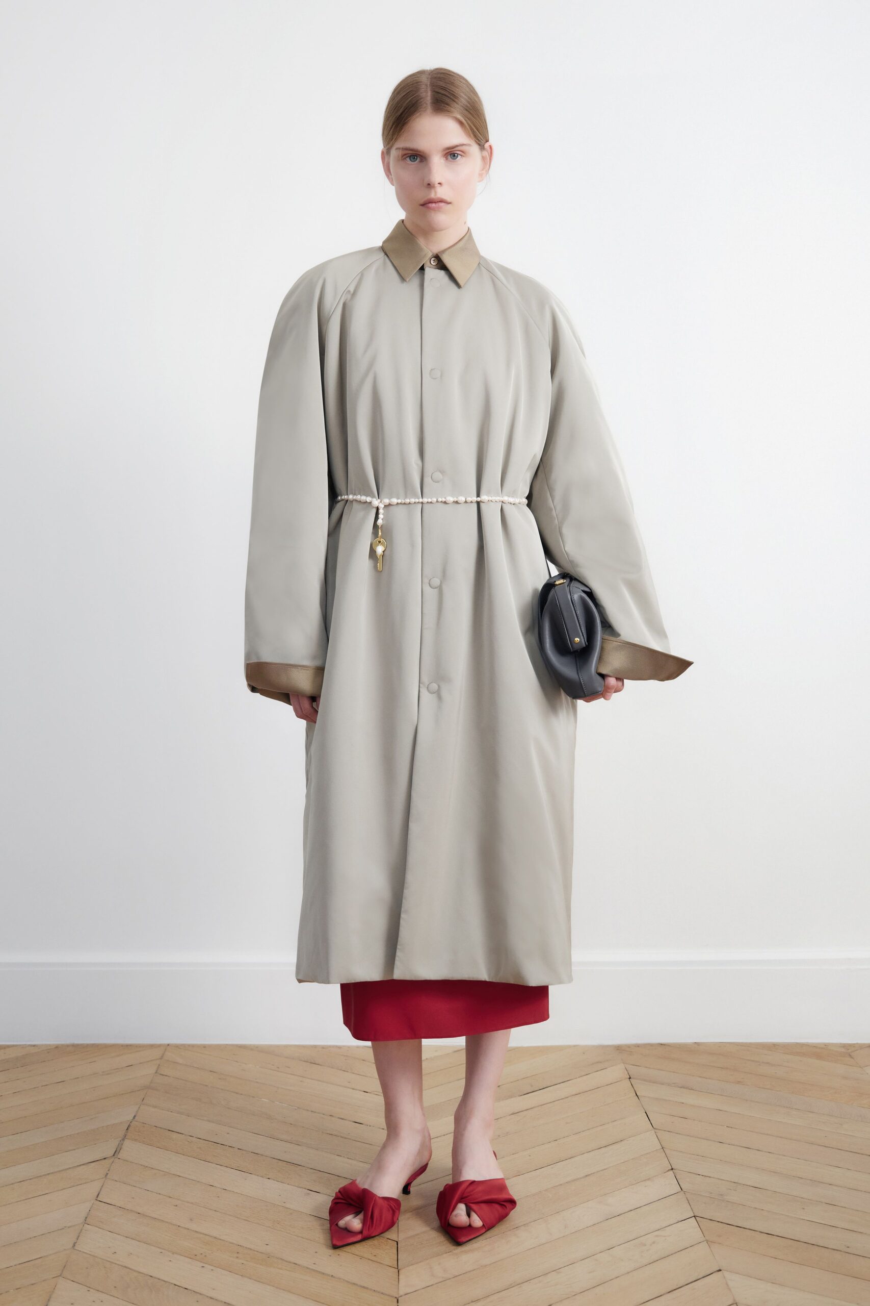 beige oversized coat with red dress